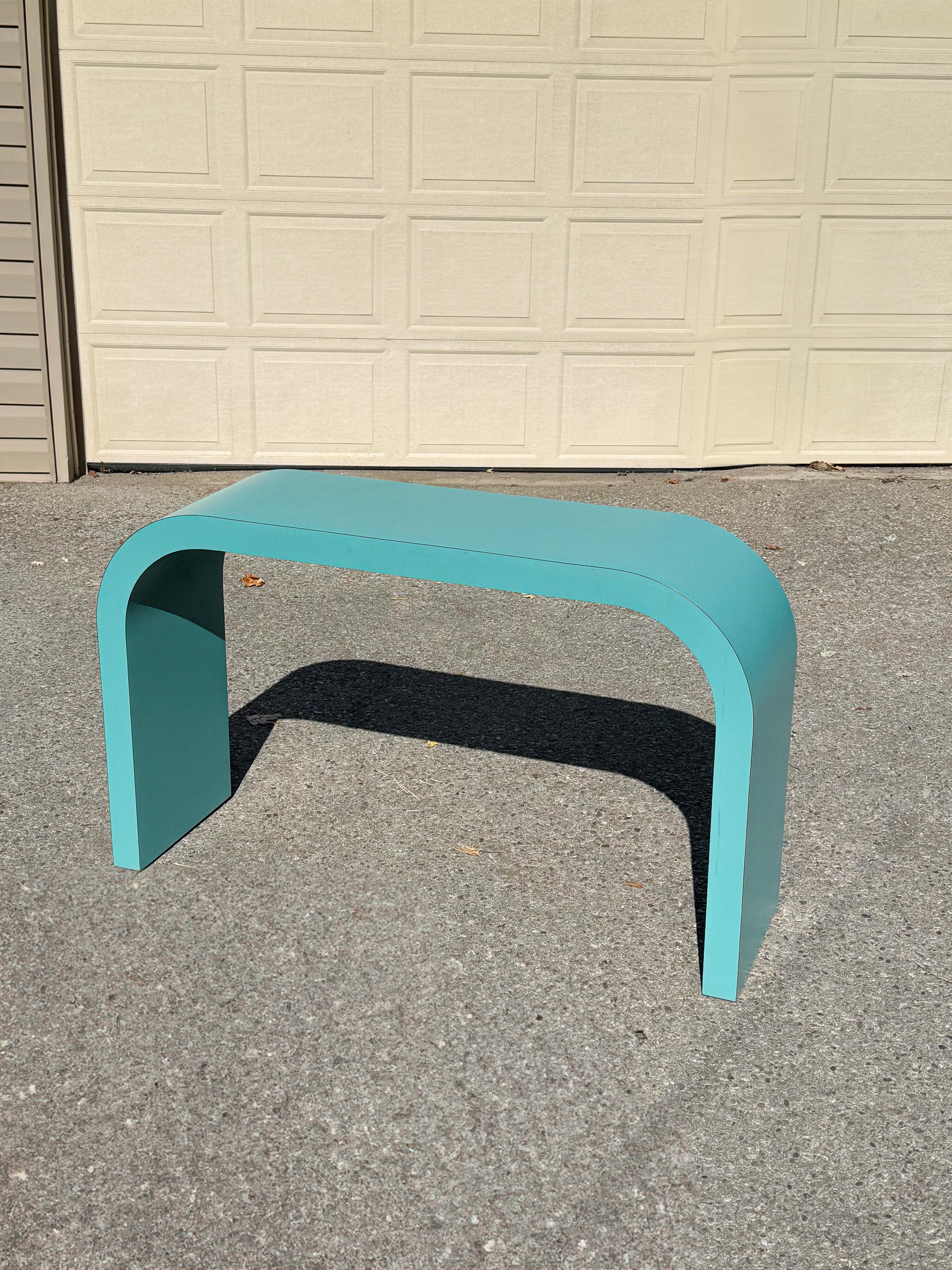 This 1980s turquoise laminated waterfall console table is a striking example of postmodern design by Jeffrey Craig, a distinguished Canadian designer known for his craftsmanship and durable laminated tables. Originally custom-made for an artist in