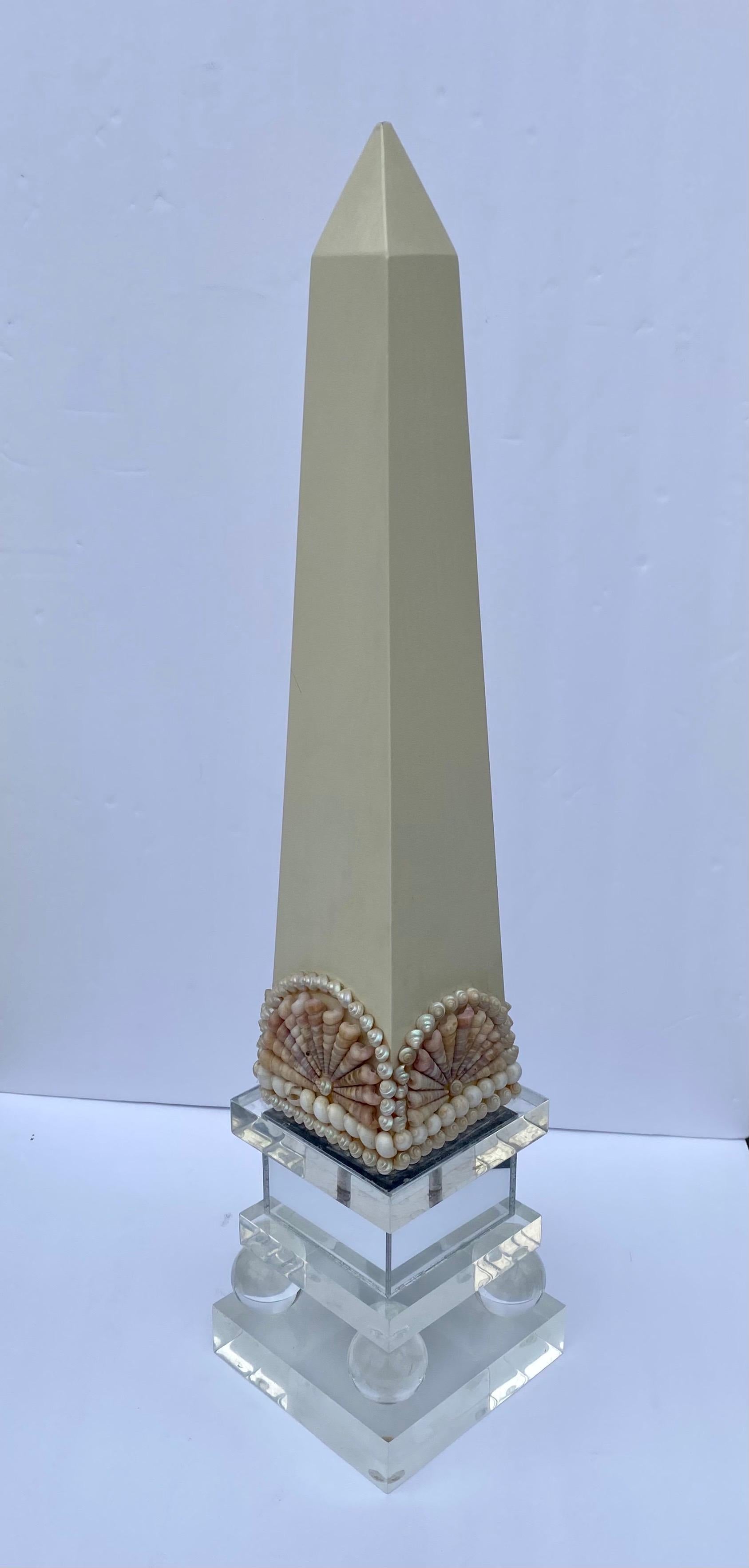 Post modern 1980s Lucite and shell mirrored obelisk table sculpture.
 
  