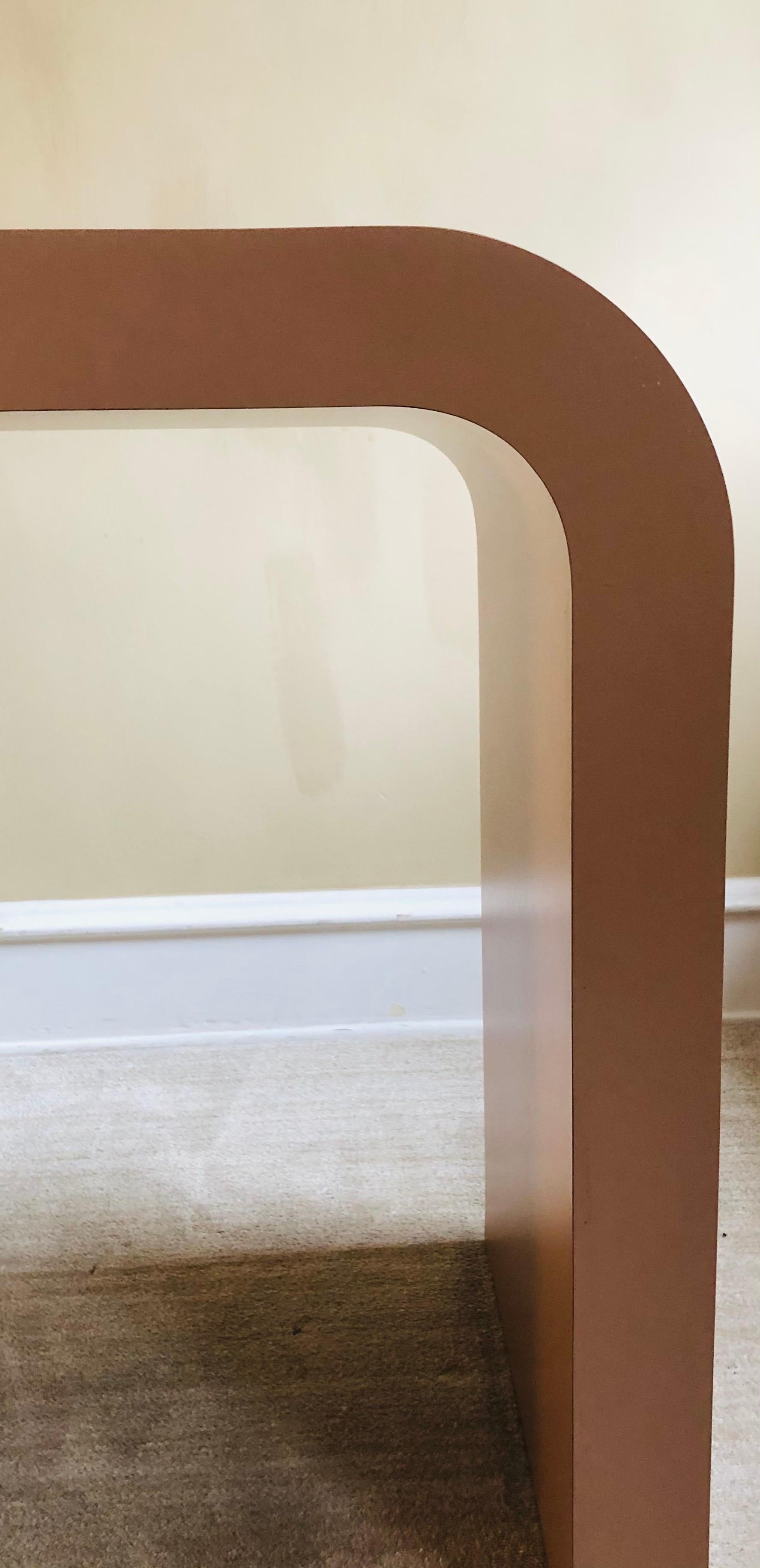 This table is so much fun.

Its substantial, unlike many other period Formica consoles in this style.

Its hue is between a darker blush or a lighter mauve, dependent on the room's lighting.

The span of this table is 60 inches wide, she's a