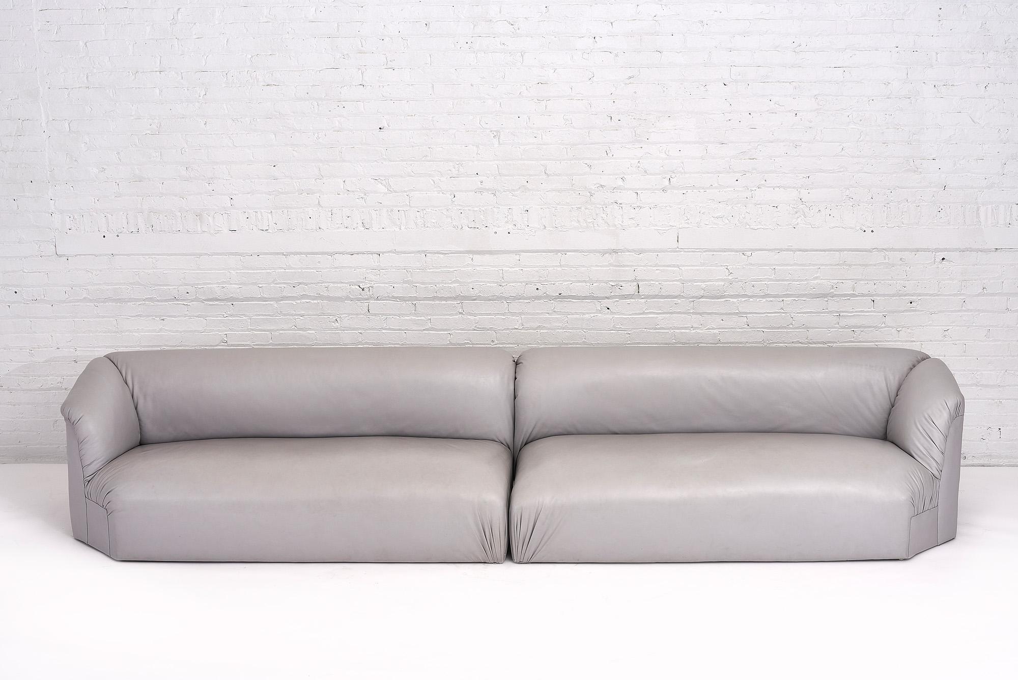 Postmodern 2 piece gray leather sectional sofas. 2 Piece modular sofa can be used as shown or used in a corner. High quality supple and smooth grey leather.