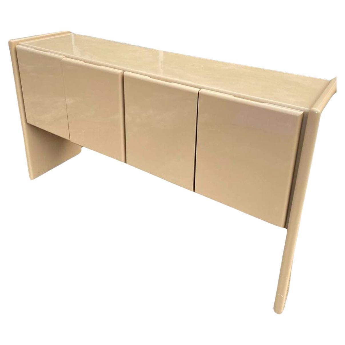 Post modern 4 door credenza taupe Lacquer Gloss finish by Milo Baughman for Thayer Coggin. Has (4) cabinet doors has (2) drawers on the left and (2) glass shelves on the left. Get simple design. Labeled in drawer. Good vintage condition. Located in