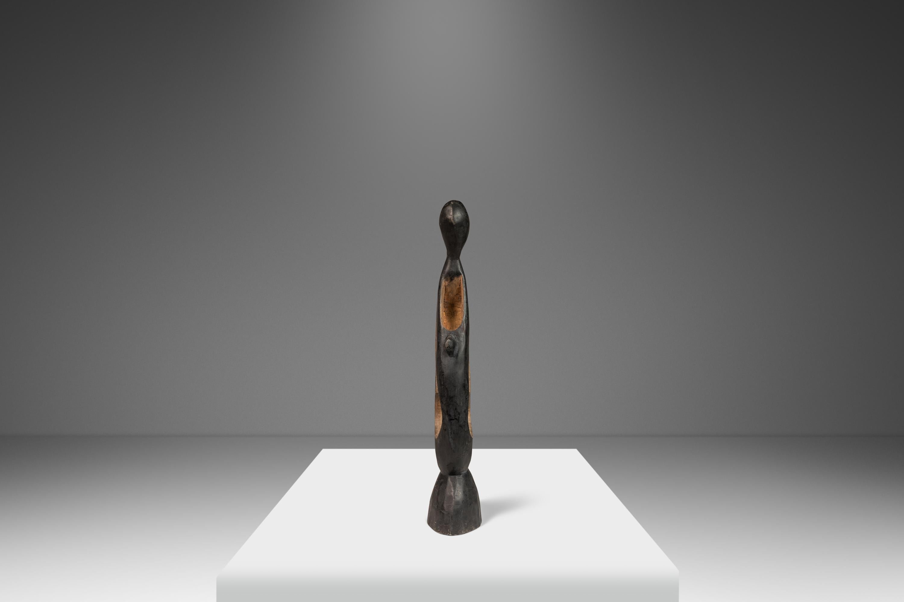 Introducing a heart-warming abstract sculpture depicting a parent with child in embrace. Hand-carved in solid walnut with an alluring ebonized this exquisite, visually captivating sculpture is the perfect gift to new parents or for collectors