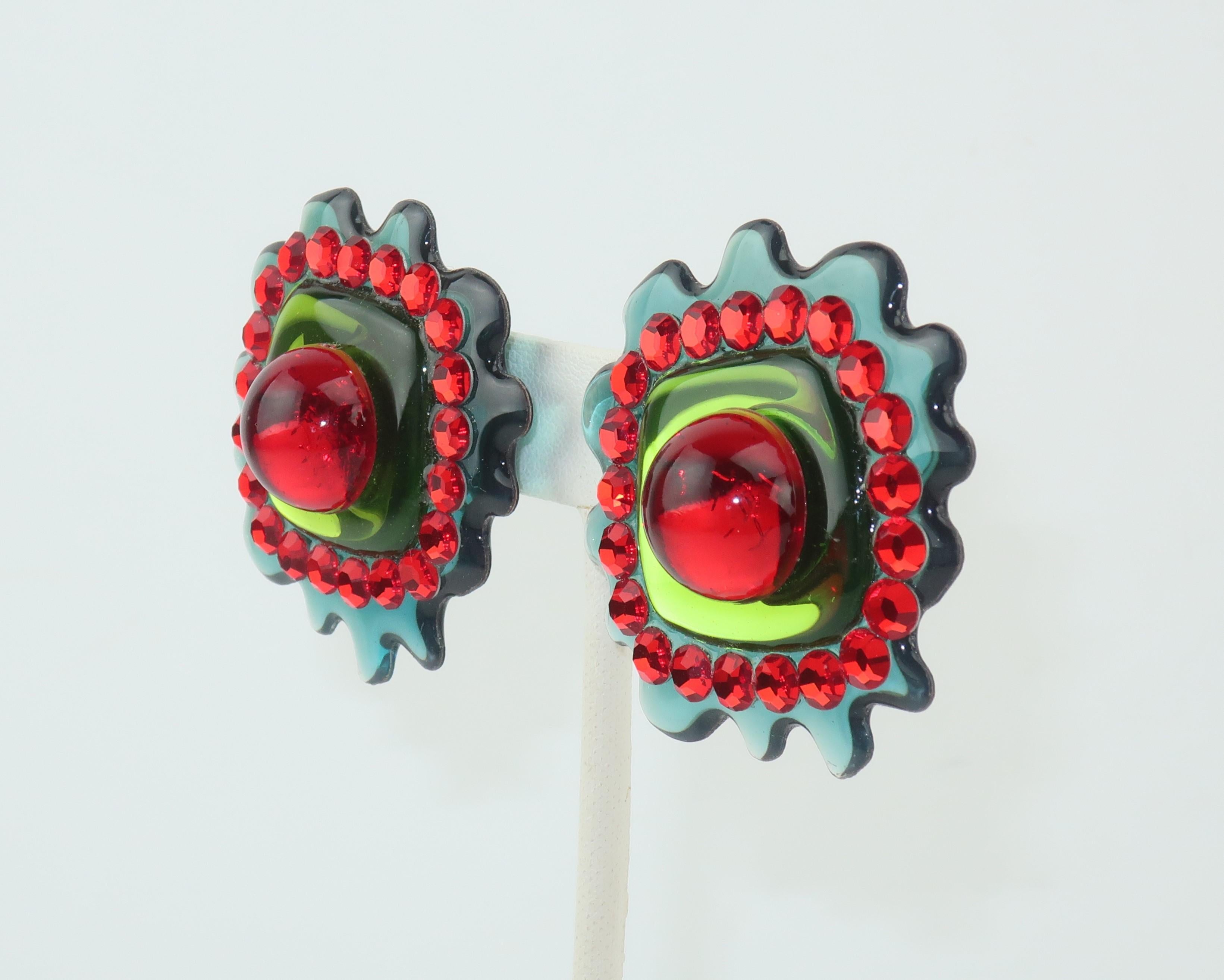 These fun 1980’s clip on earrings are an explosion of color with a great pop art style reminiscent of Roy Lichtenstein graphics.  A sea mist green amoeba base serves as a frame to a ring of red pave crystals and a spring green center accented with a