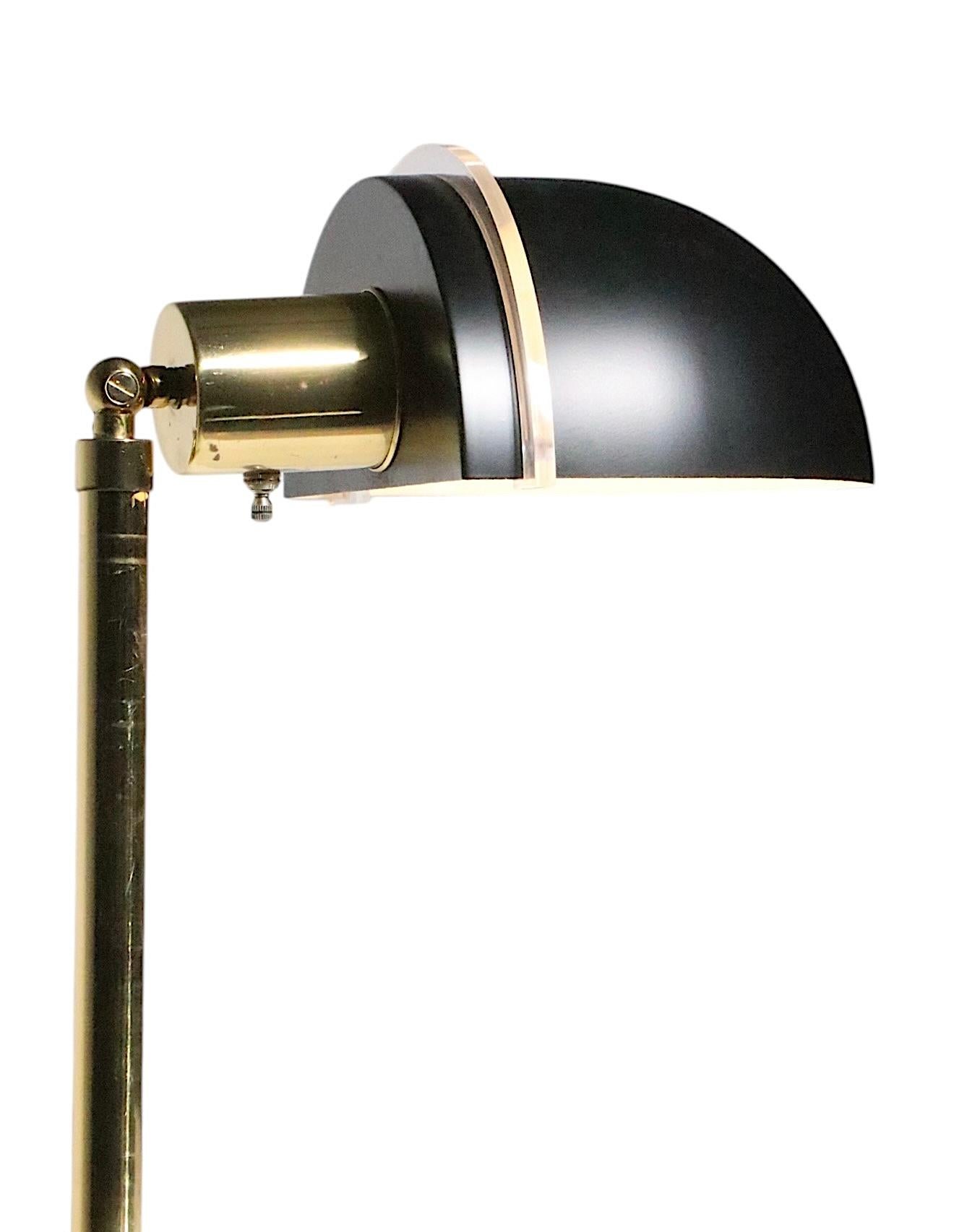 Chic post modern adjustable floor lamp, having a brass center pole, which extends to raise and lower the shade. The hood shade adjusts up and down,  and the black hood shade can be tilted side to side, to perfectly position the light. 
 The hood