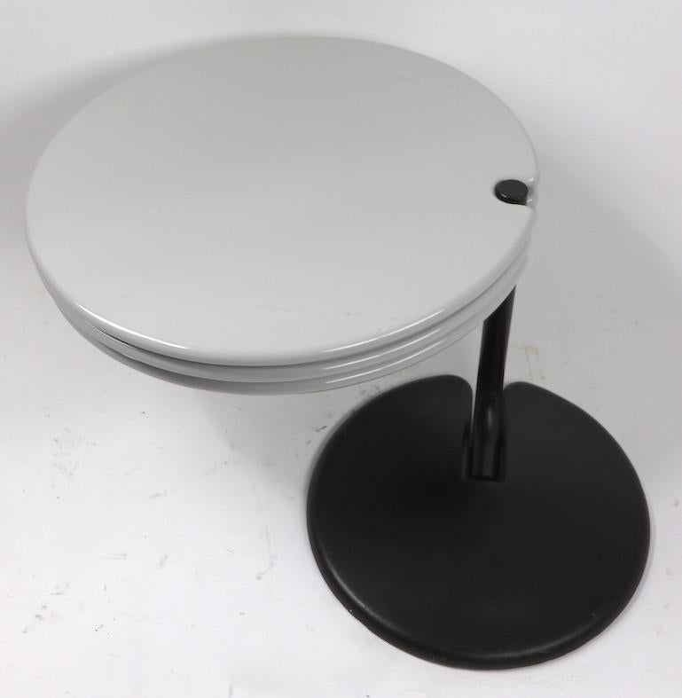 Playful and architectural three level end table. This interesting stand has swing out disk table surfaces, each 23.5 inch diameter. Very heavy and well constructed, top quality design, and materials, probably Italian made. Width with disks extended