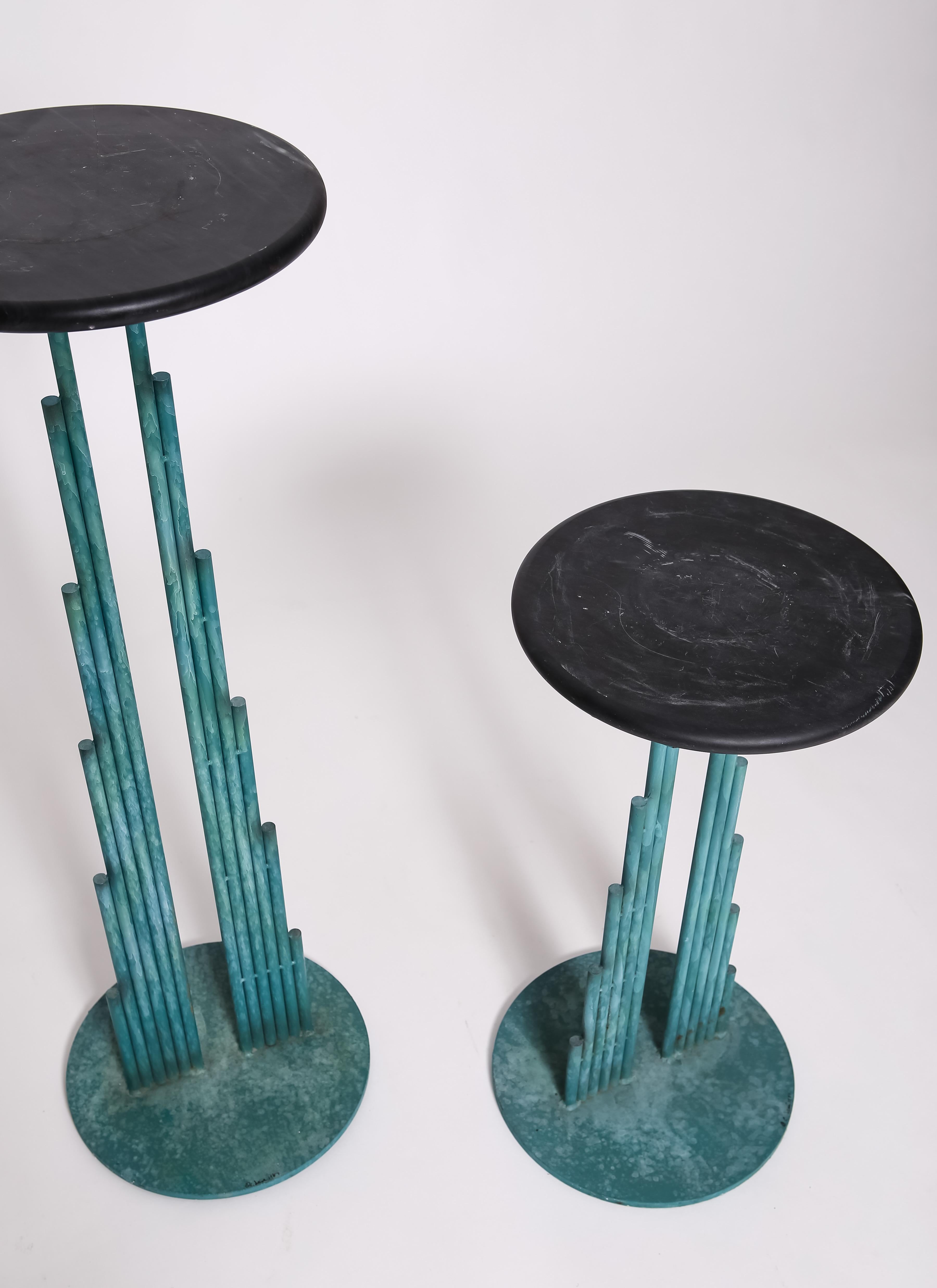 Verdigris-effect painted steel pedestals with removable slate tops, signed at base C.Jeré 1987. Pair. 24” & 36” heights with 11” diameter tops. Really cool uncommon design; great for plants. Finish is all original in great condition. Rare. 