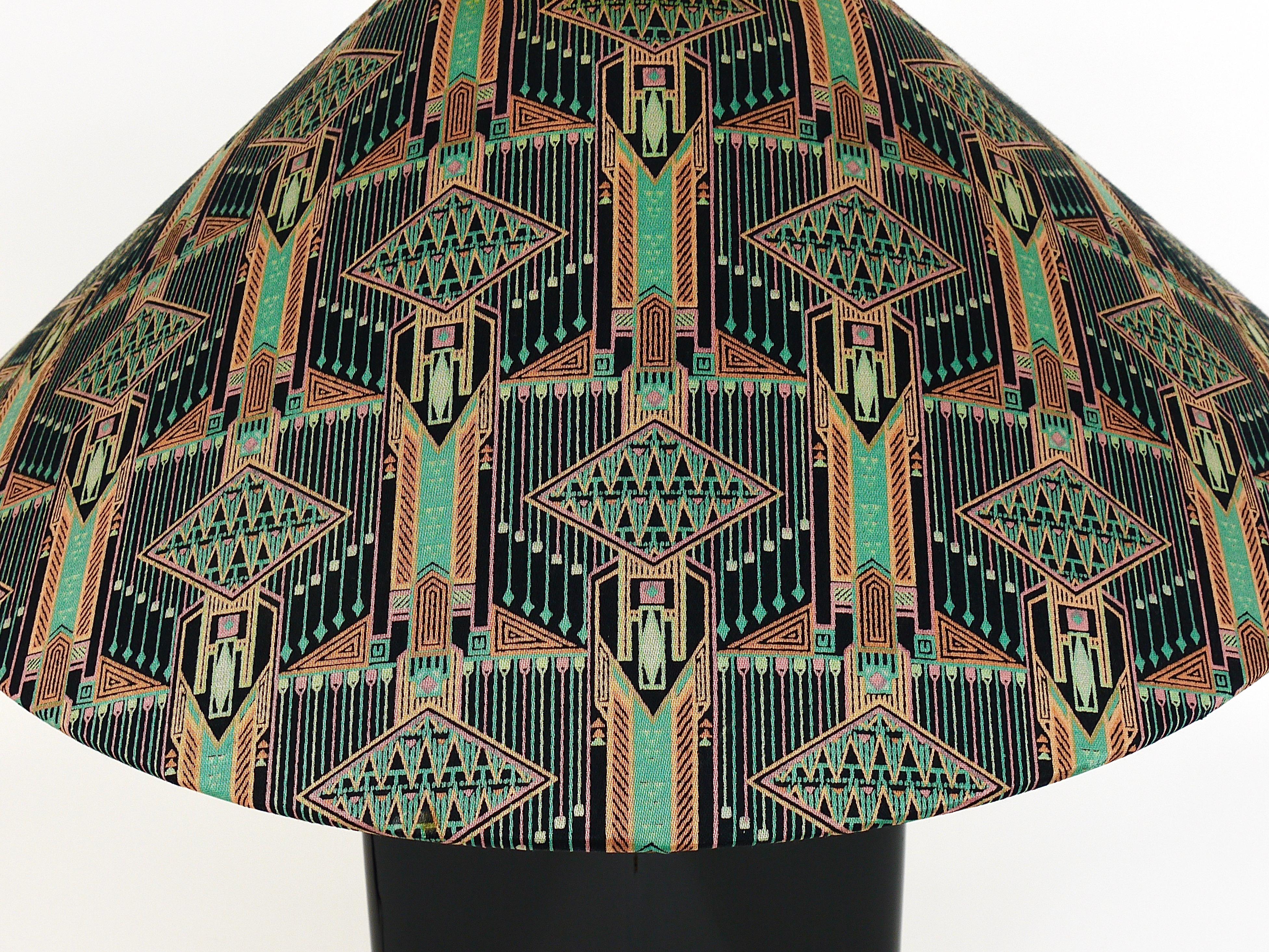 A beautiful Italian postmodern table lamp / side lamp from the 1980s. The lamps base is made of ceramic with a black shiny glaze, a brass neck and its original lampshade with an adorable Art Deco / Art Nouveau pattern in the style of Josef Hoffmann