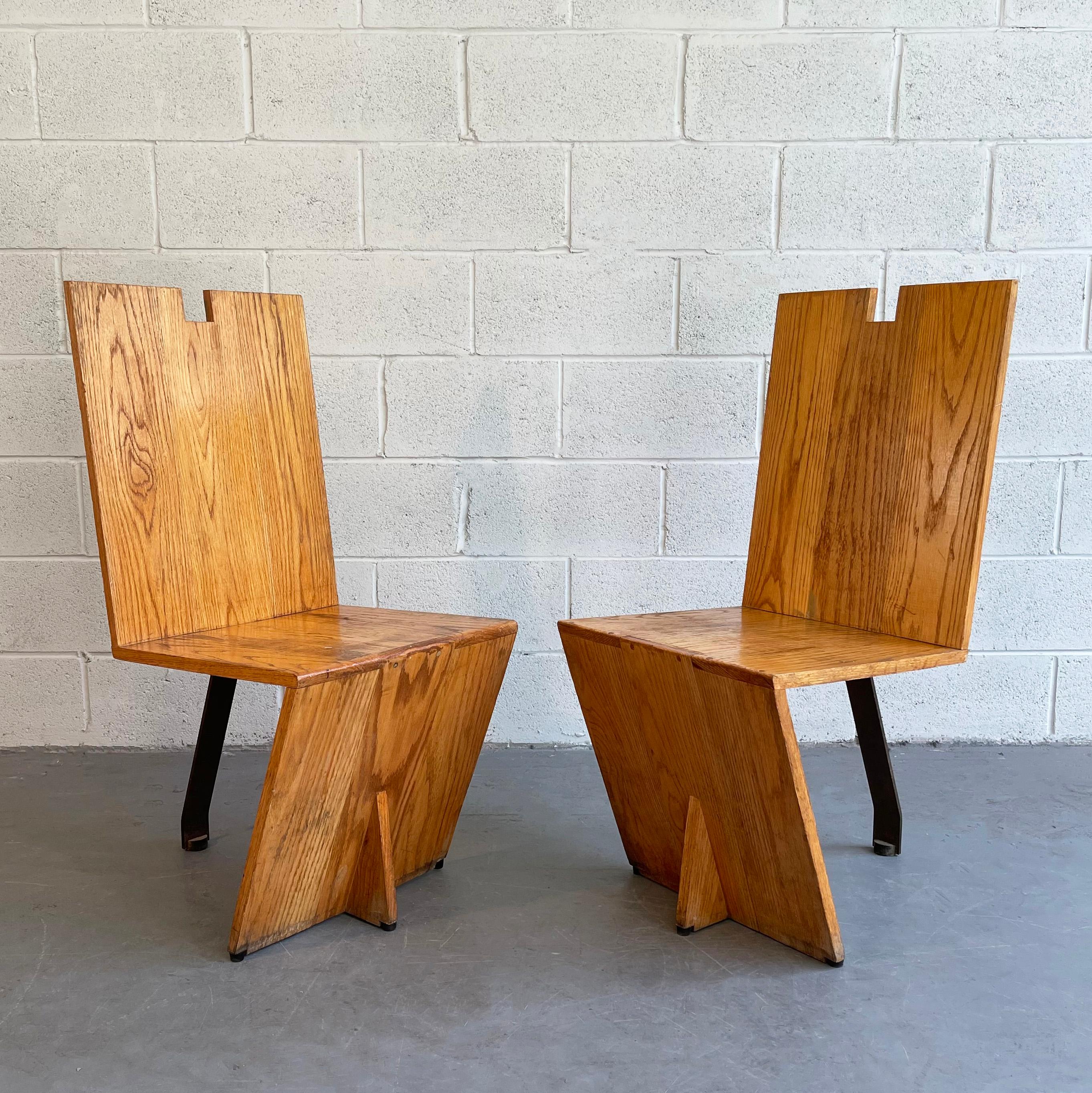 Pair of minimal, post modern, artisan-made chairs feature angular oak backs, seats and fronts with a single steel leg in back. Interesting from all angles.