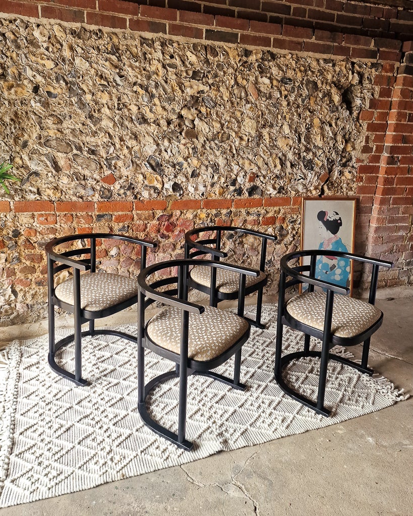 This set of four rare Joseph Hoffmann-style chairs made in Denmark in 1960s designed by John R. Eckel Jr. are the perfect addition to any dining room or kitchen in need of modernist or eclectic flair. Crafted from bentwood and ebonized black frames,