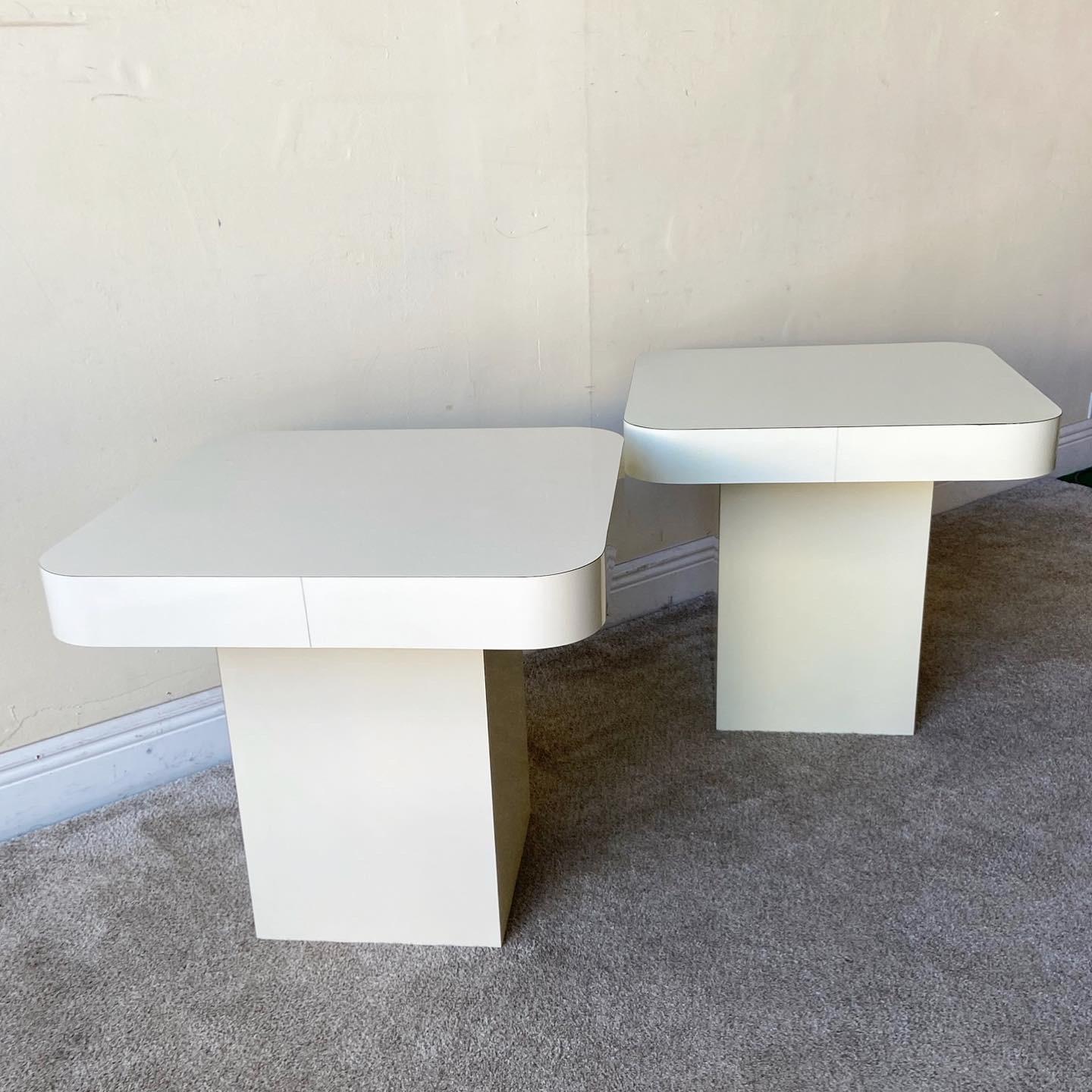 Amazing pair of square top mushroom side table. Each features rounded edges. One of the tables is a very light beige and the other is a cream.
