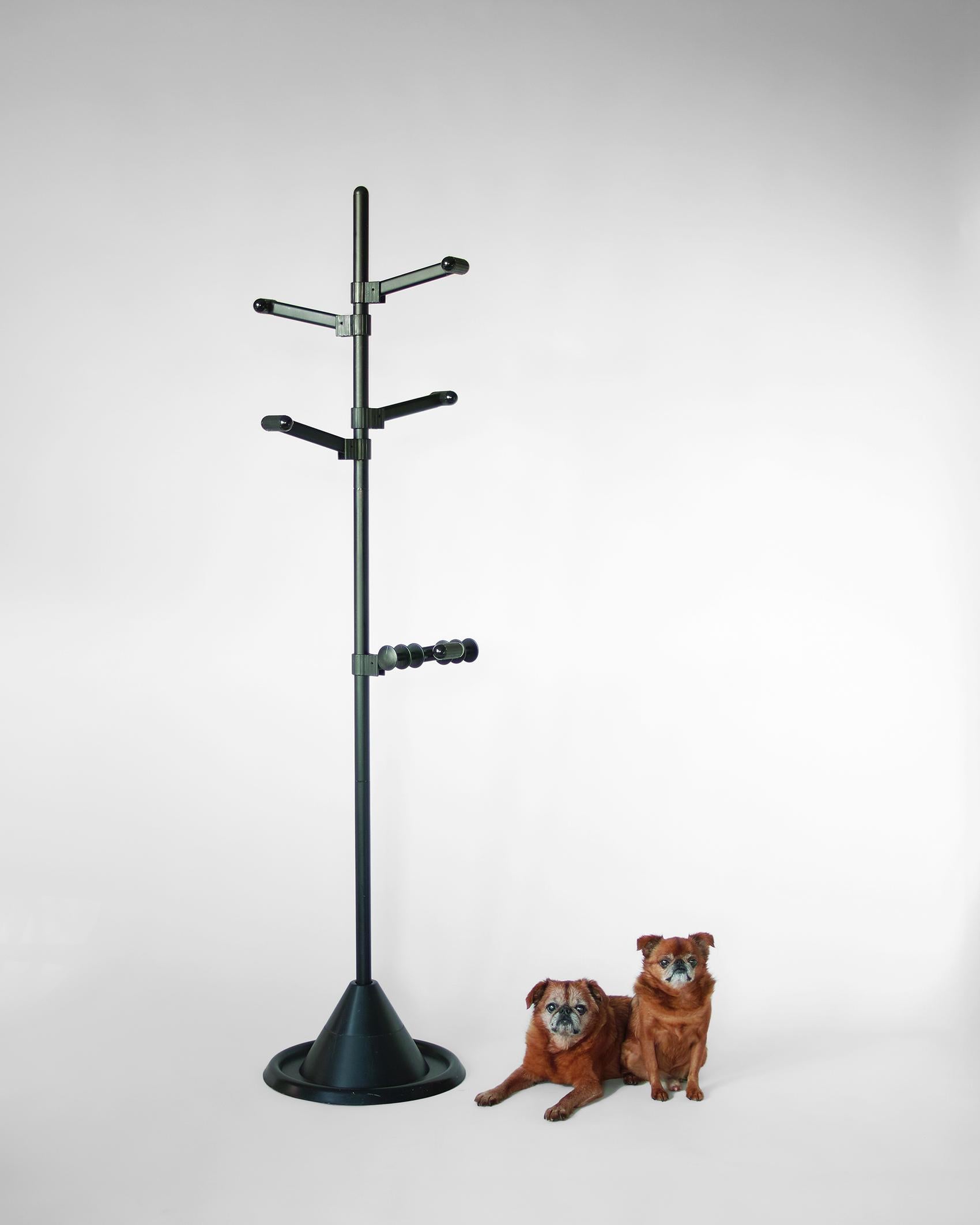 For your consideration is this post-modern coat rack featuring original black finish, five adjustable arms, and nicely weighted conical base. Each arm can raised or lowered and rotated around the central pole. The central pole is comprised of three