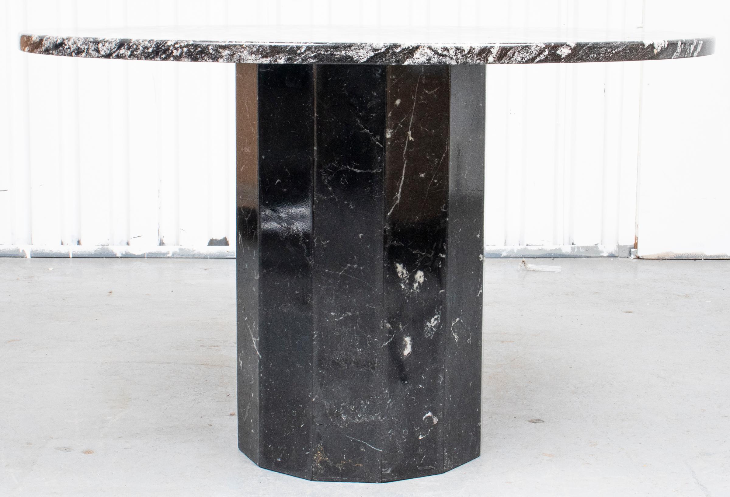 Post-Modern black and white marble dining table with round top over column base. Measures: 30” height x 48” diameter.