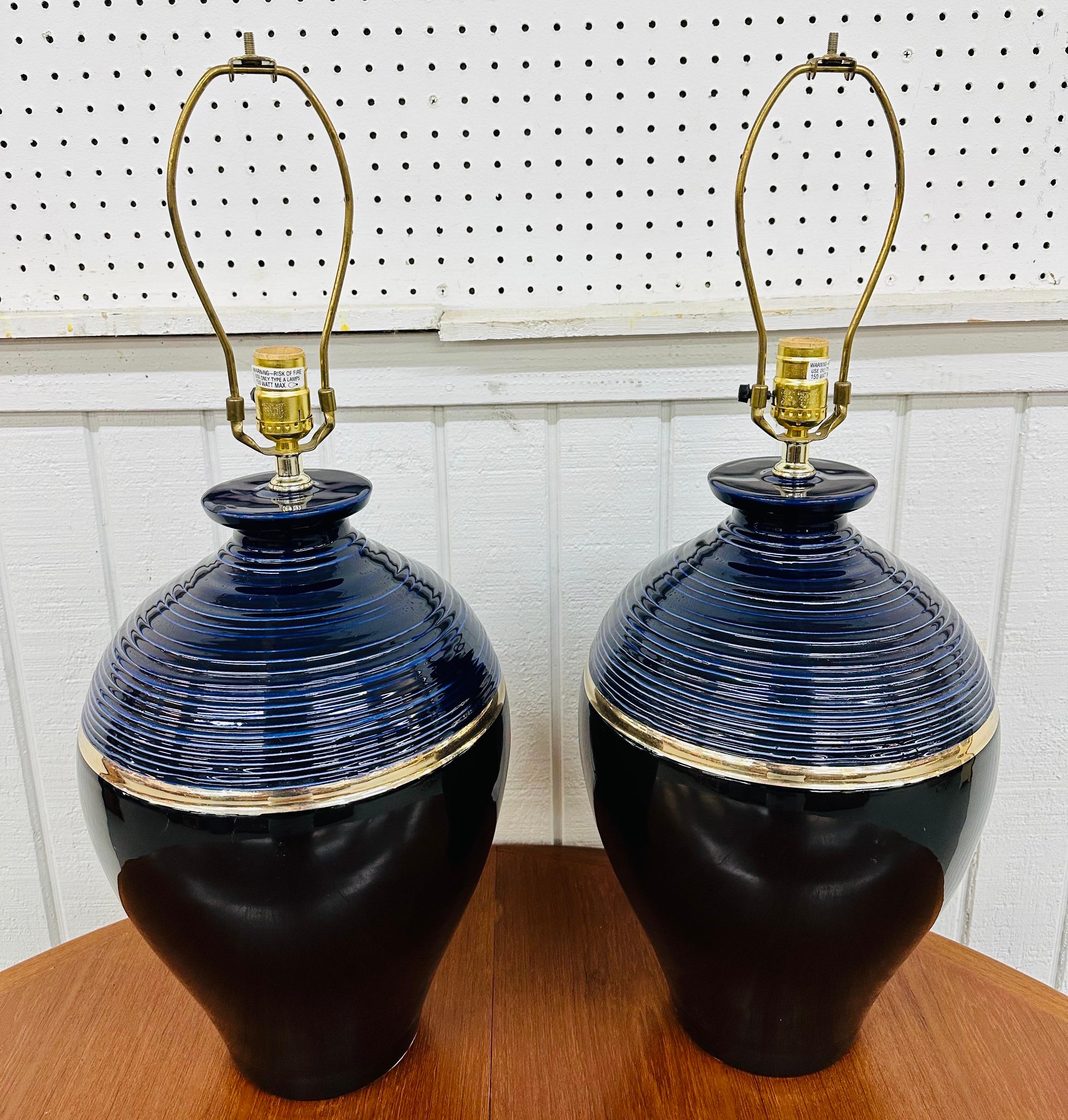 This listing is for a pair of Post-Modern Ceramic Table Lamps. Featuring a black, navy blue, and gold body, brass necks and harps, and original shades. This is an exceptional combination of quality and design from the 1980’s!