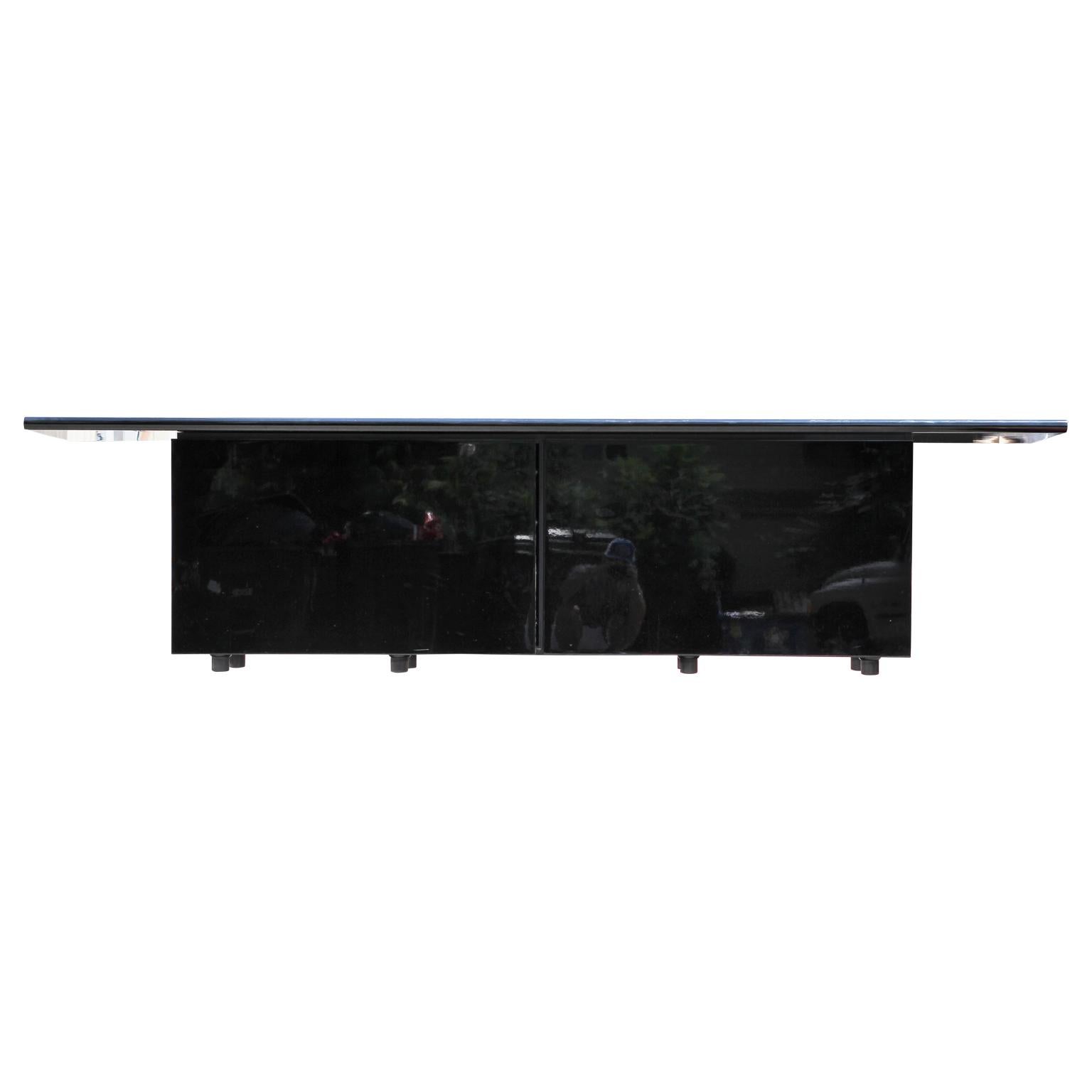 Postmodern cabinet with a sleek and sophisticated look. The storage cabinet consist of two outward sliding doors that expose four storage drawers and an open cabinet.
