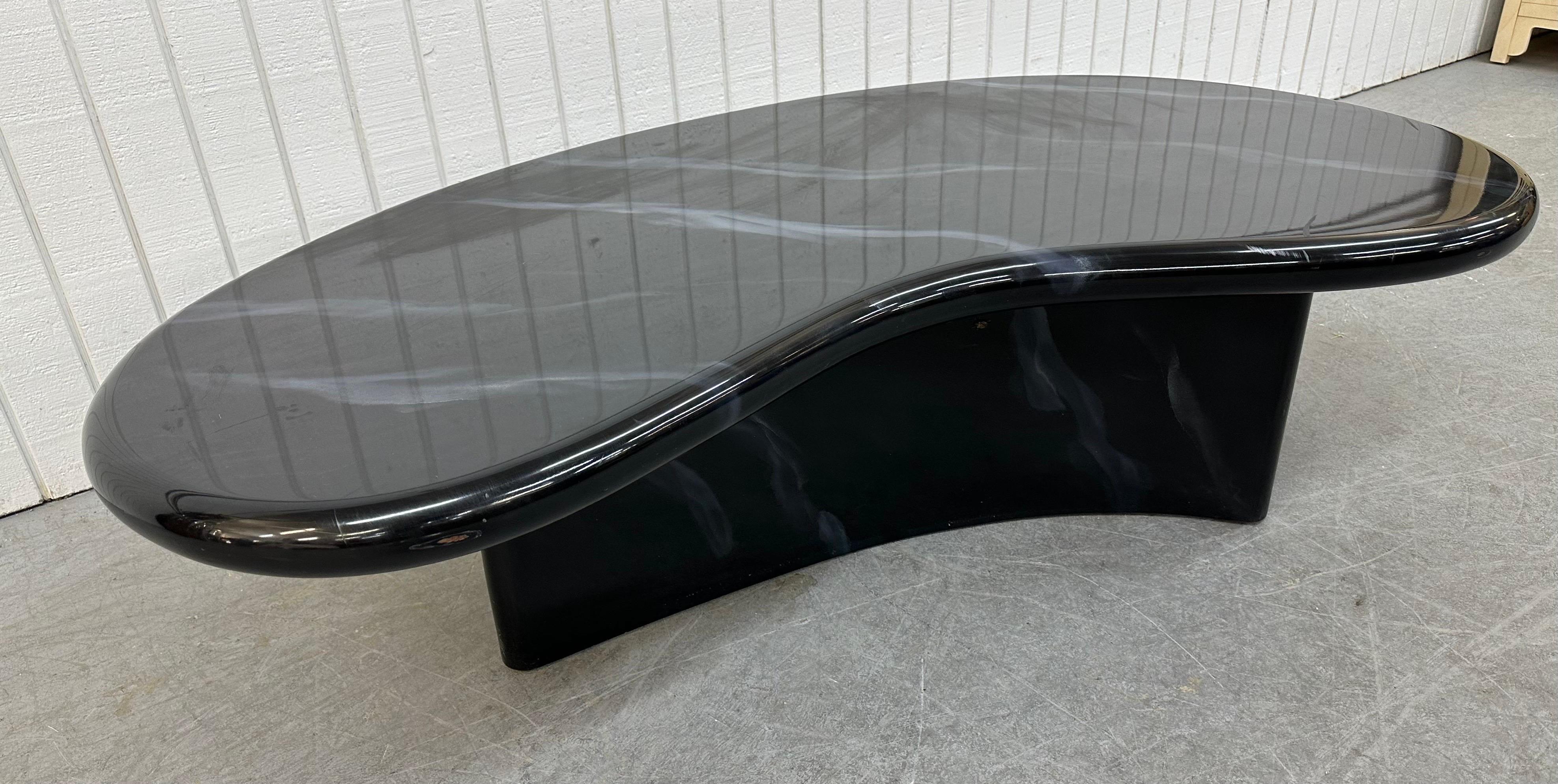 This listing is for a Post-Modern Black Lacquered Coffee Table. Featuring a kidney shaped design, pedestal base, and a beautiful black lacquered finish. This is an exceptional combination of quality and post modernism design!