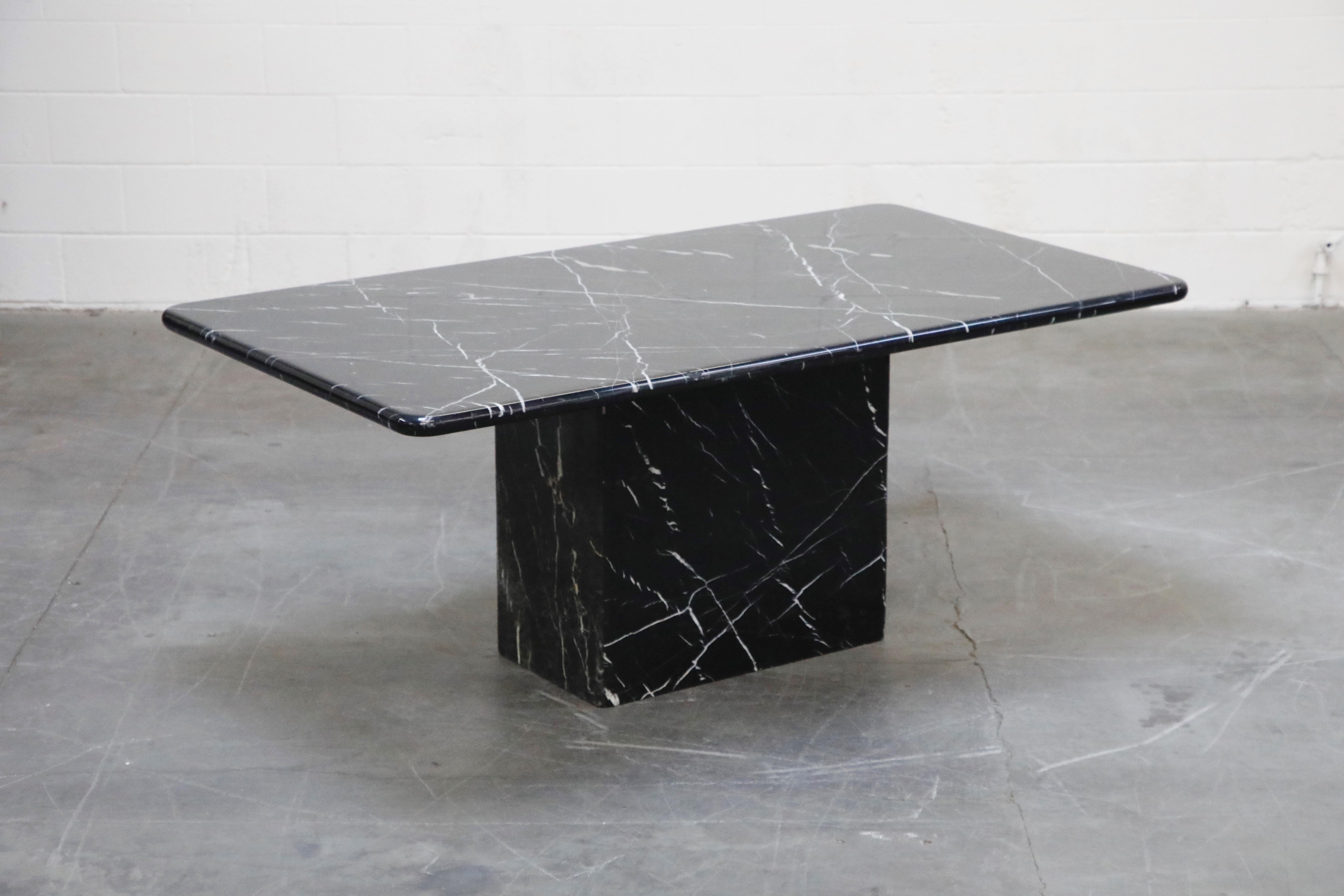 This lovely dining table is constructed of black marble with white veining and a thick protective lacquer coat over the dining table top. The base is constructed of thick marble in a rectangular form and hollow on the inside - yet is still