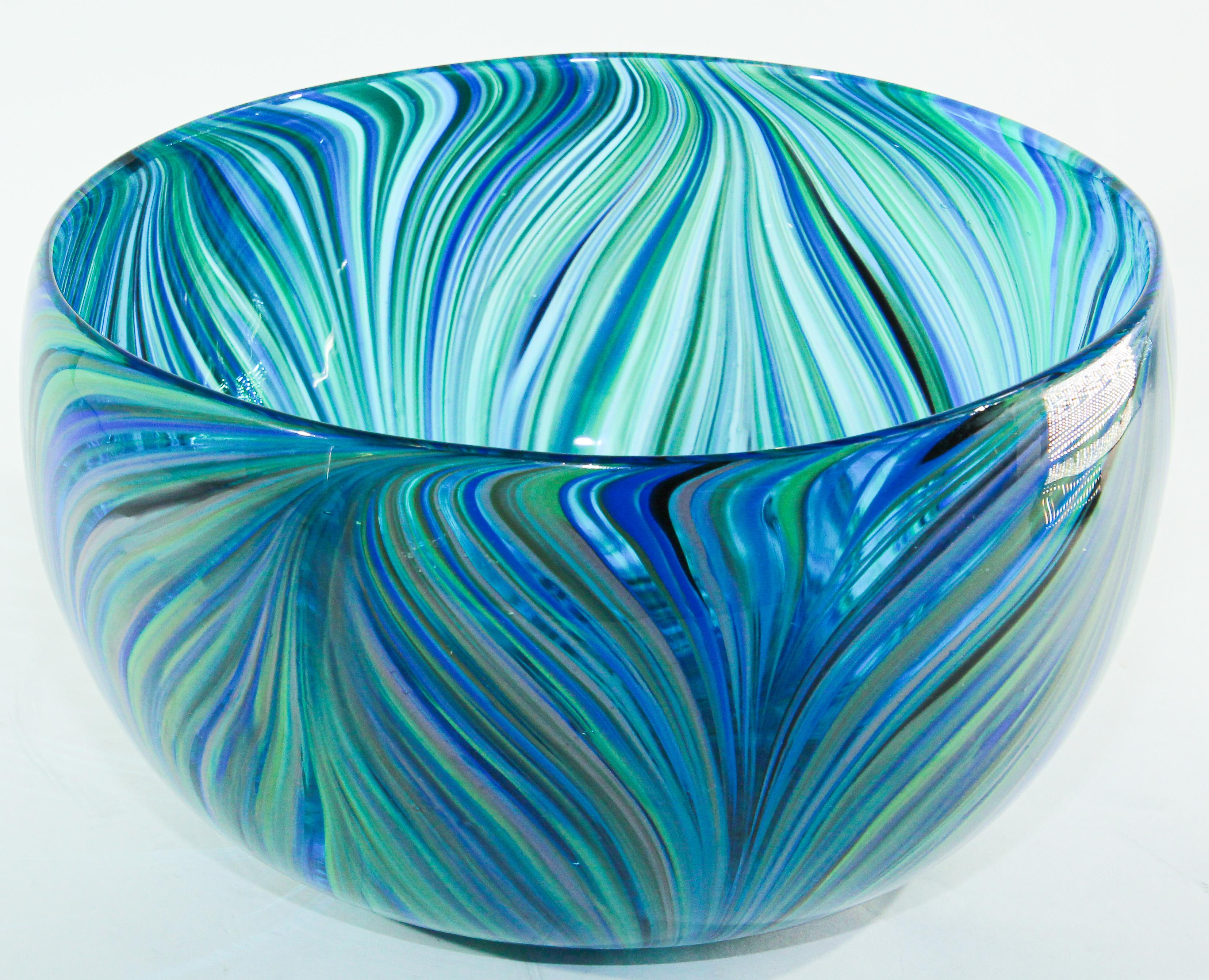 Large Art Glass Bowl in blue and green peacock colors. 
Large vintage exquisite post modern decorative hand blown Murano style art crystal glass bowl with a swirl stylized design in an amazing royal cobalt blue, turquoise and green and other