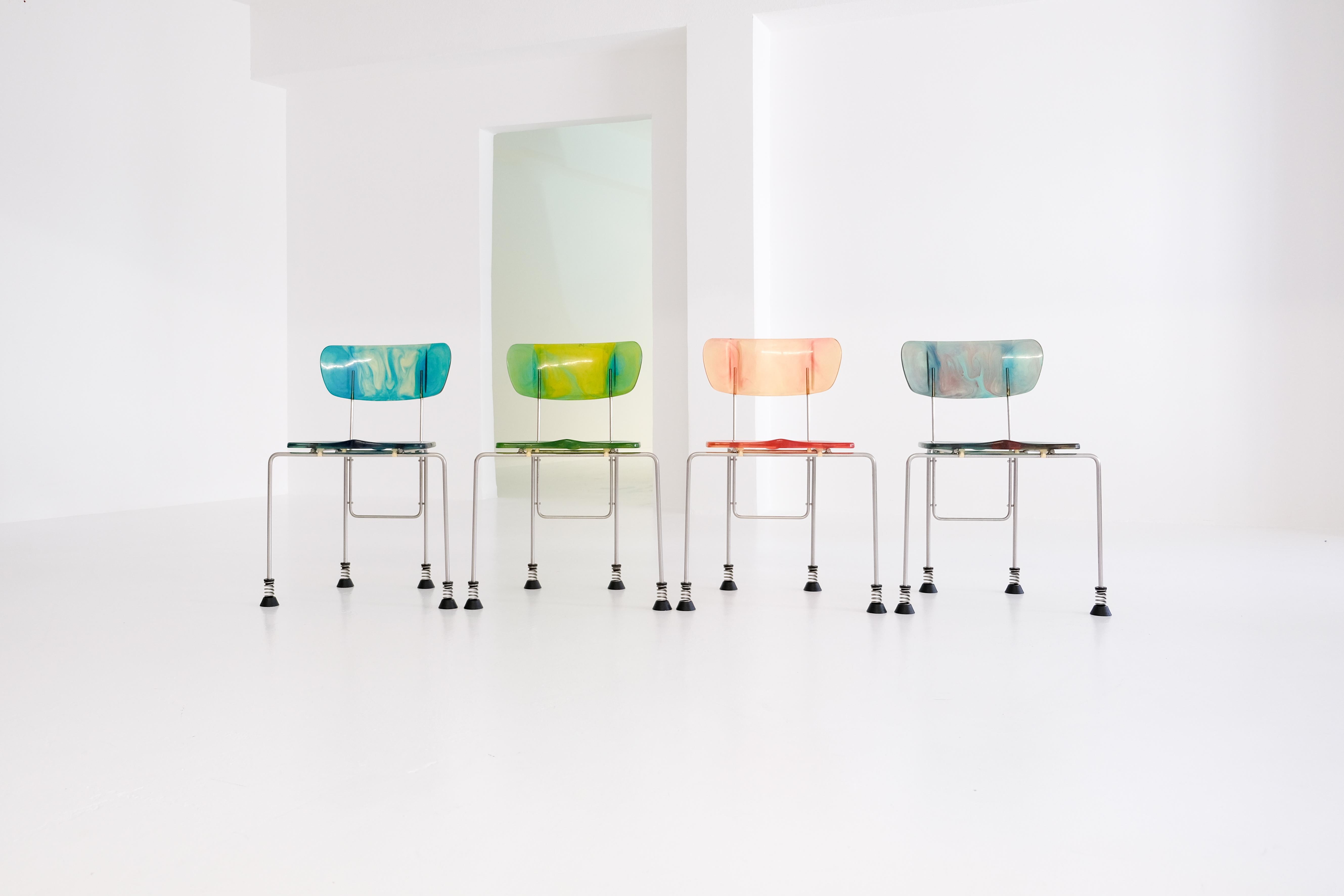 gaetano pesce, set of 4 ‚broadway‘ chairs for italian company bernini, 1993.

multicoloured cast epoxy resin, brushed steel legs, spring and rubber-capped feet. all chairs signed with cast manufacturer’s mark under the seat: ‚des gaetano pesce