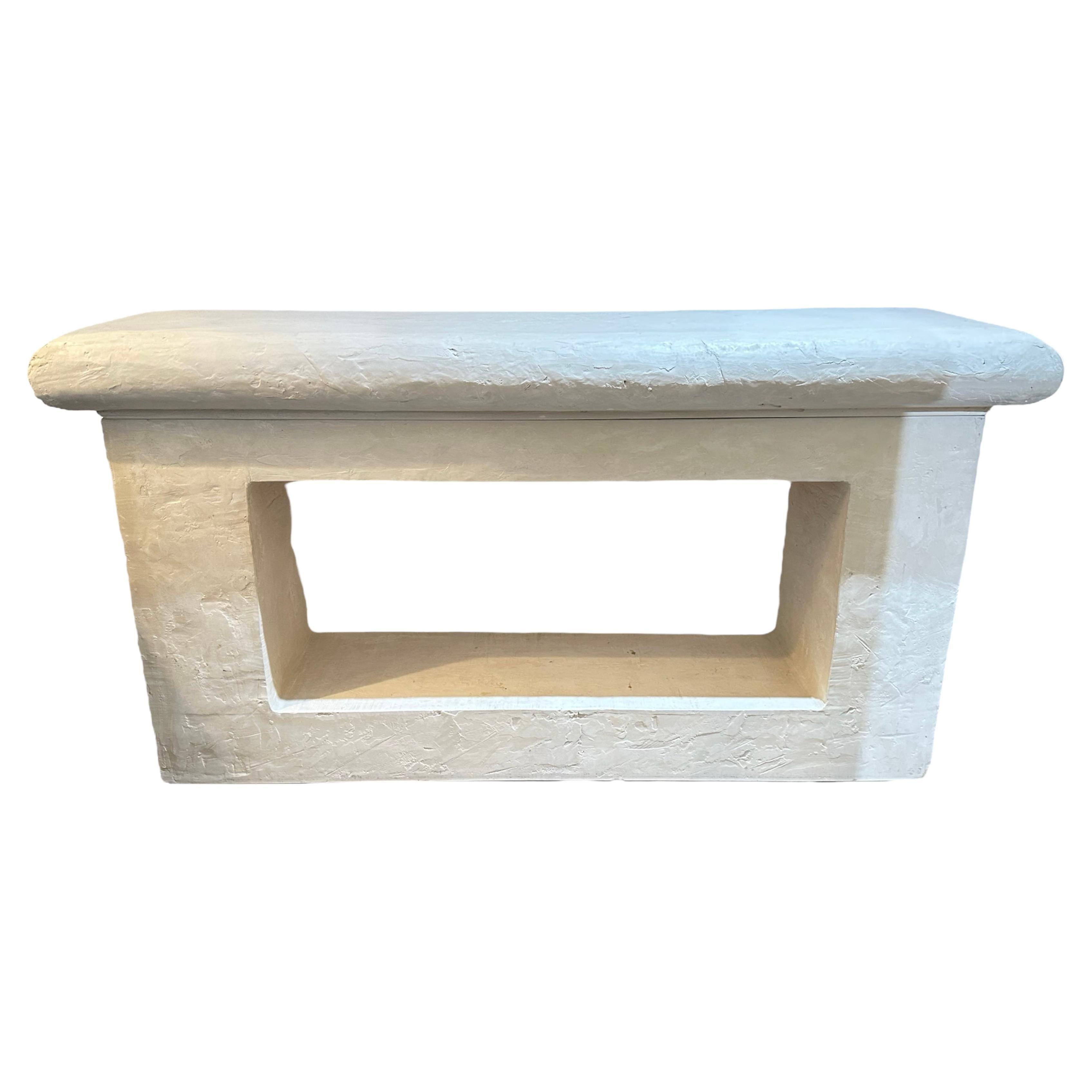 Post Modern console, there’s a very interesting piece it looks like cement or a stone, but it’s a casted plaster of some sorts very well-made and what makes it fabulous is that it’s two pieces actually, I can move it across the room on sliders quite