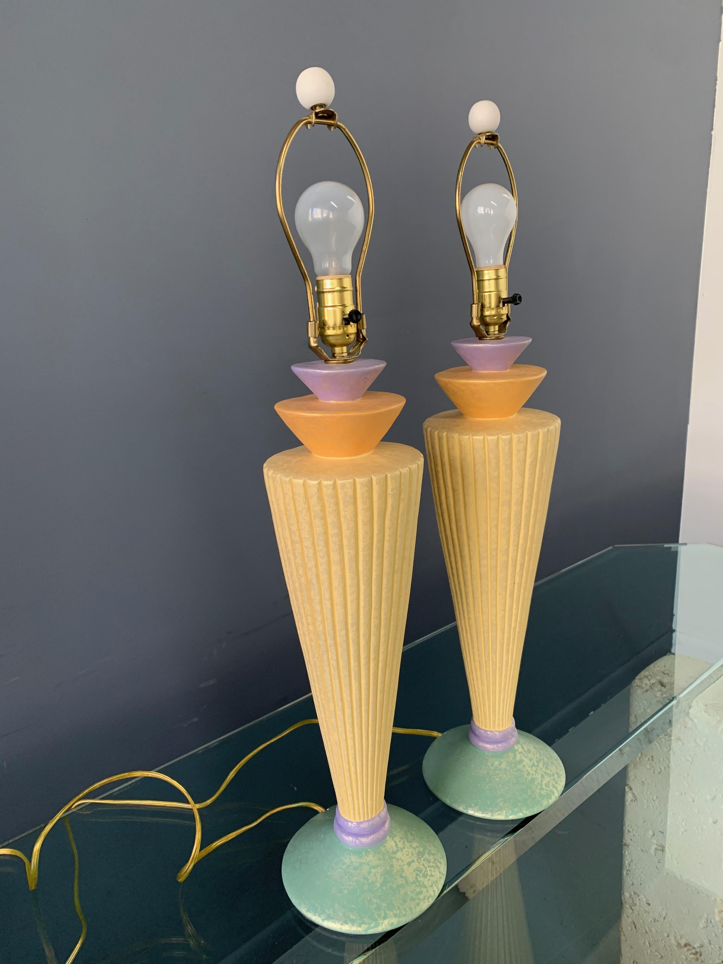 These fanciful and colorful lamps pay homage to the creative days of the postmodern era. These lamps are chalk ware, very heavy and marked Vard.