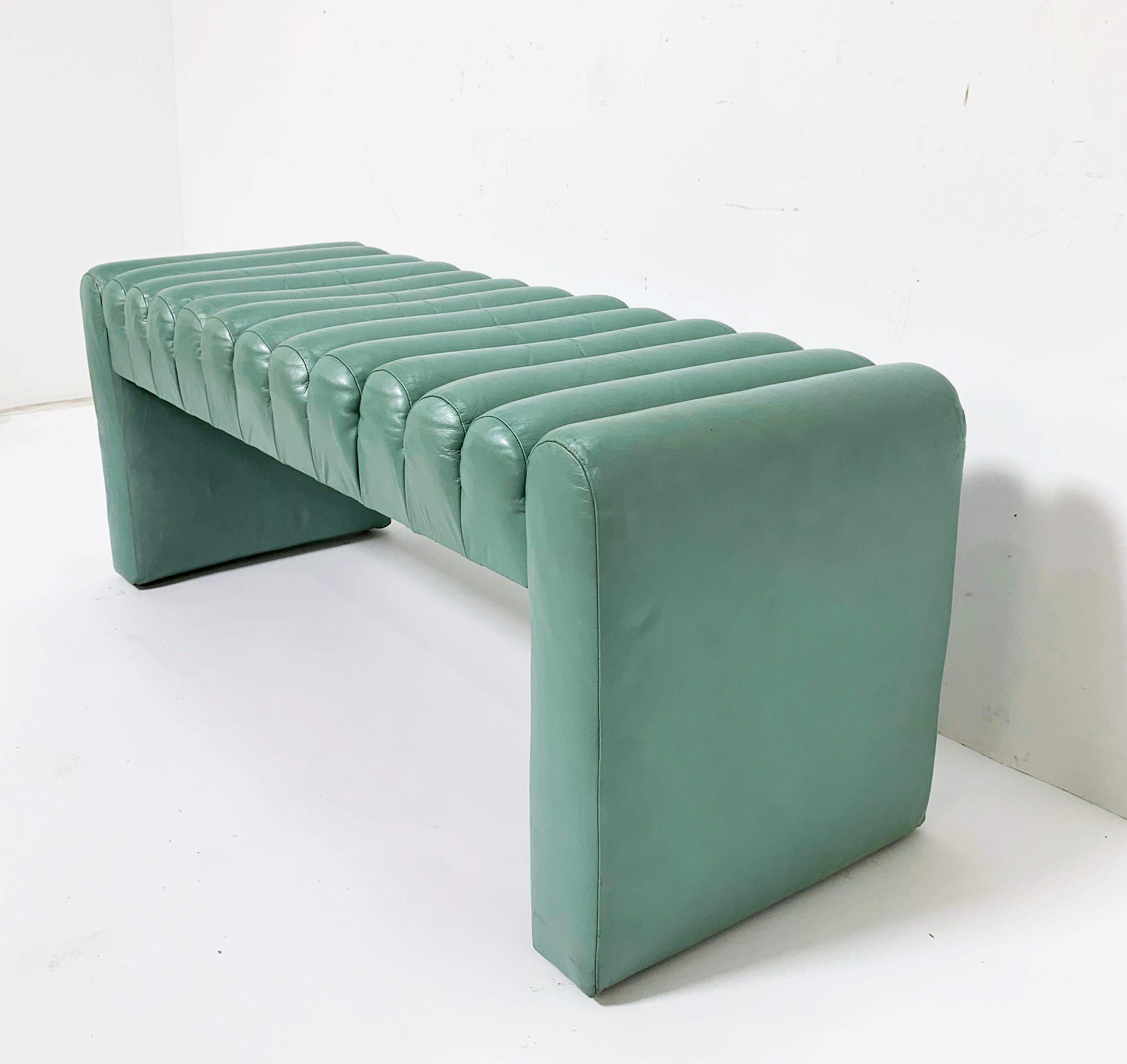 An unusual Postmodern channel form bench in aqua leather with a slight pearlescent sheen, circa 1980s.