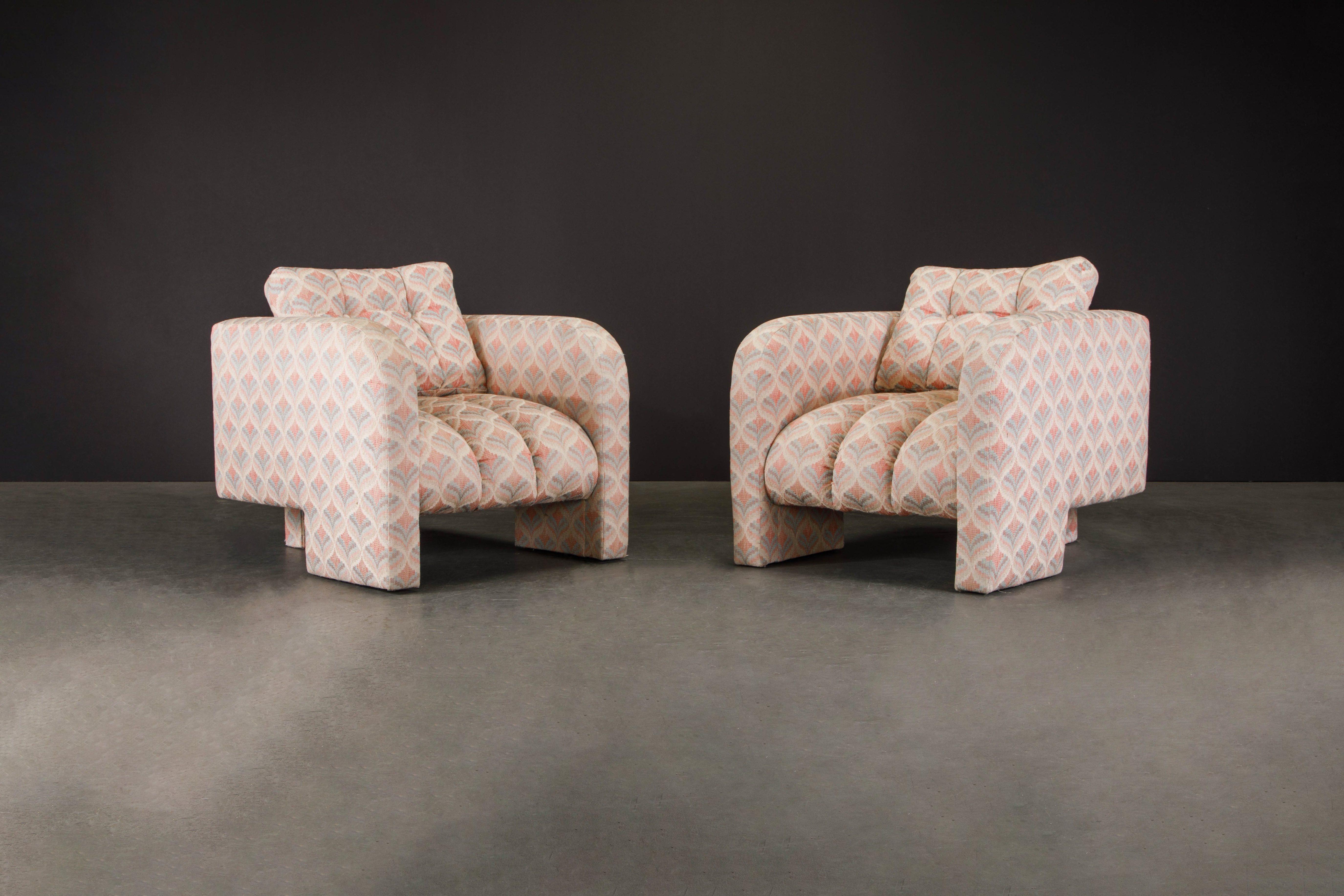 This beautiful pair of 1980s Post-Modern channel tufted lounge chairs feature three legs, one rear center leg and curved arms which morph in the front two legs, these club chairs have incredible vintage fabric with shades of pink and light blue. The