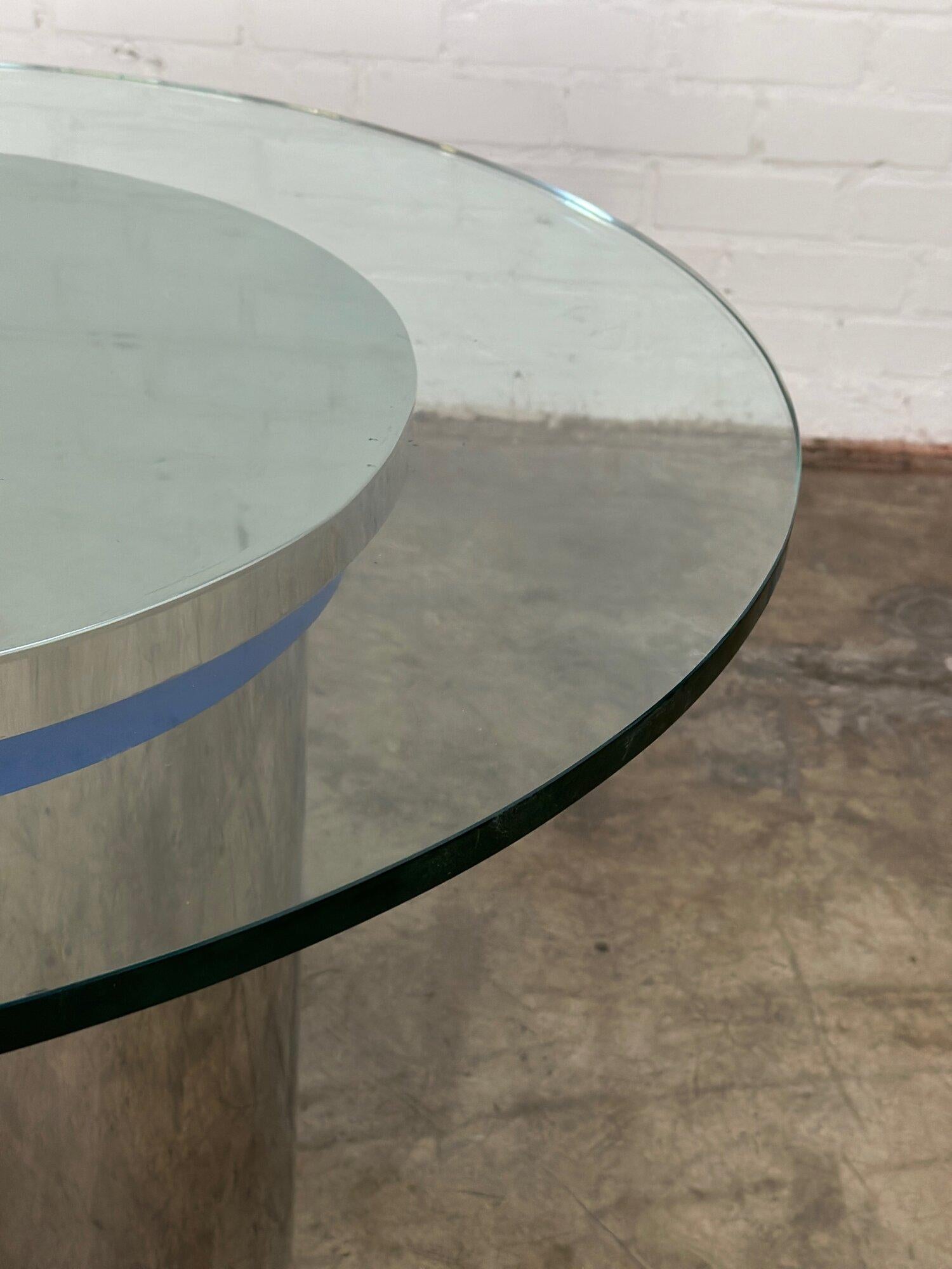 W42 D42 H30.5

VIntage chrome dining table with a blue chrome trim edge. Chrome base and glass show well with no major areas of wear, no chips in glass or peeling in chrome. Minor surface scrathces have been shown closely. 