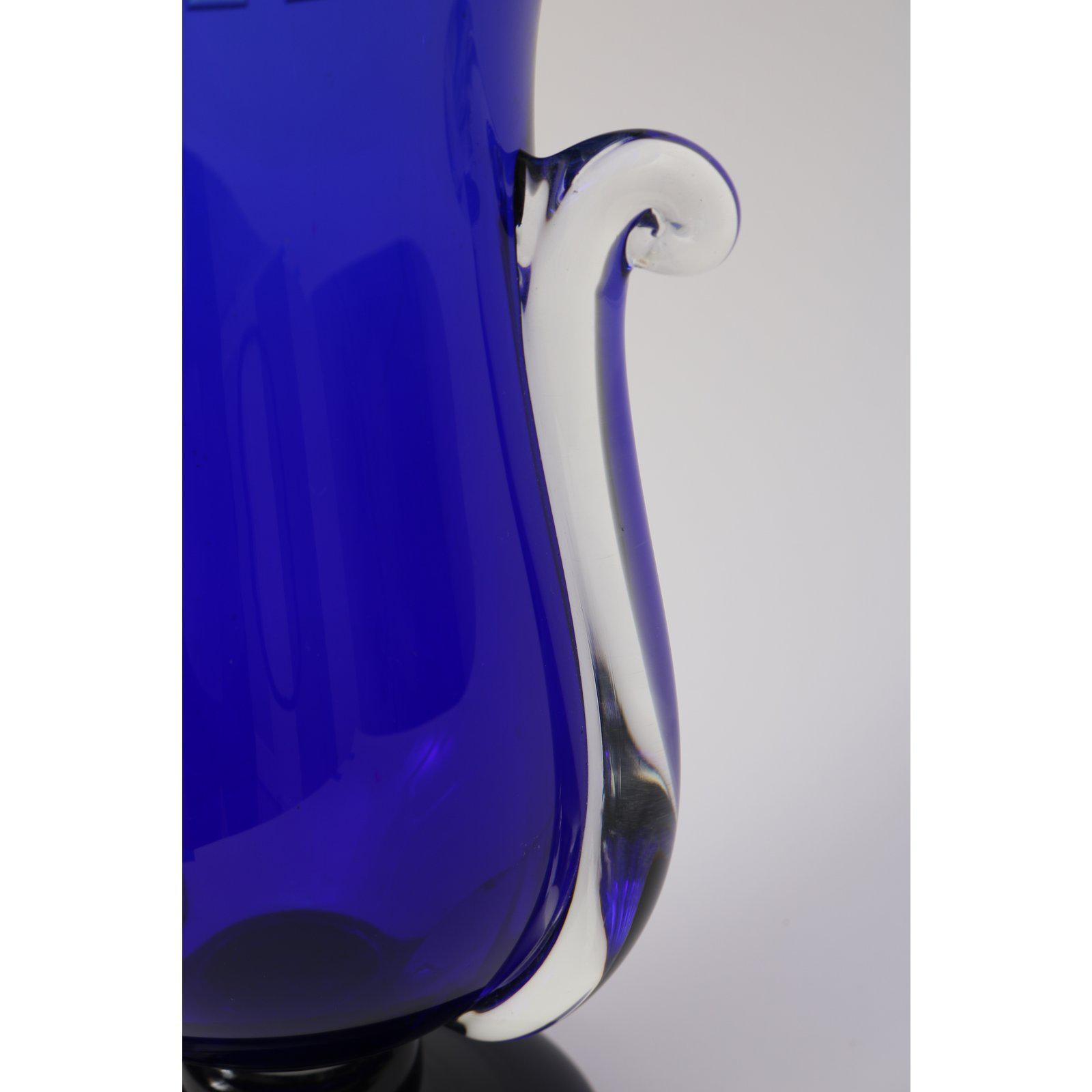 This stylish post modern vase dates to 1994 and is hand-blown in cobalt blue, clear and black glass.

Note: The neck in detailed with incised panels with a satin finish.

Note: Signed by the artist on the verso.

Note: Edition # 56/500.