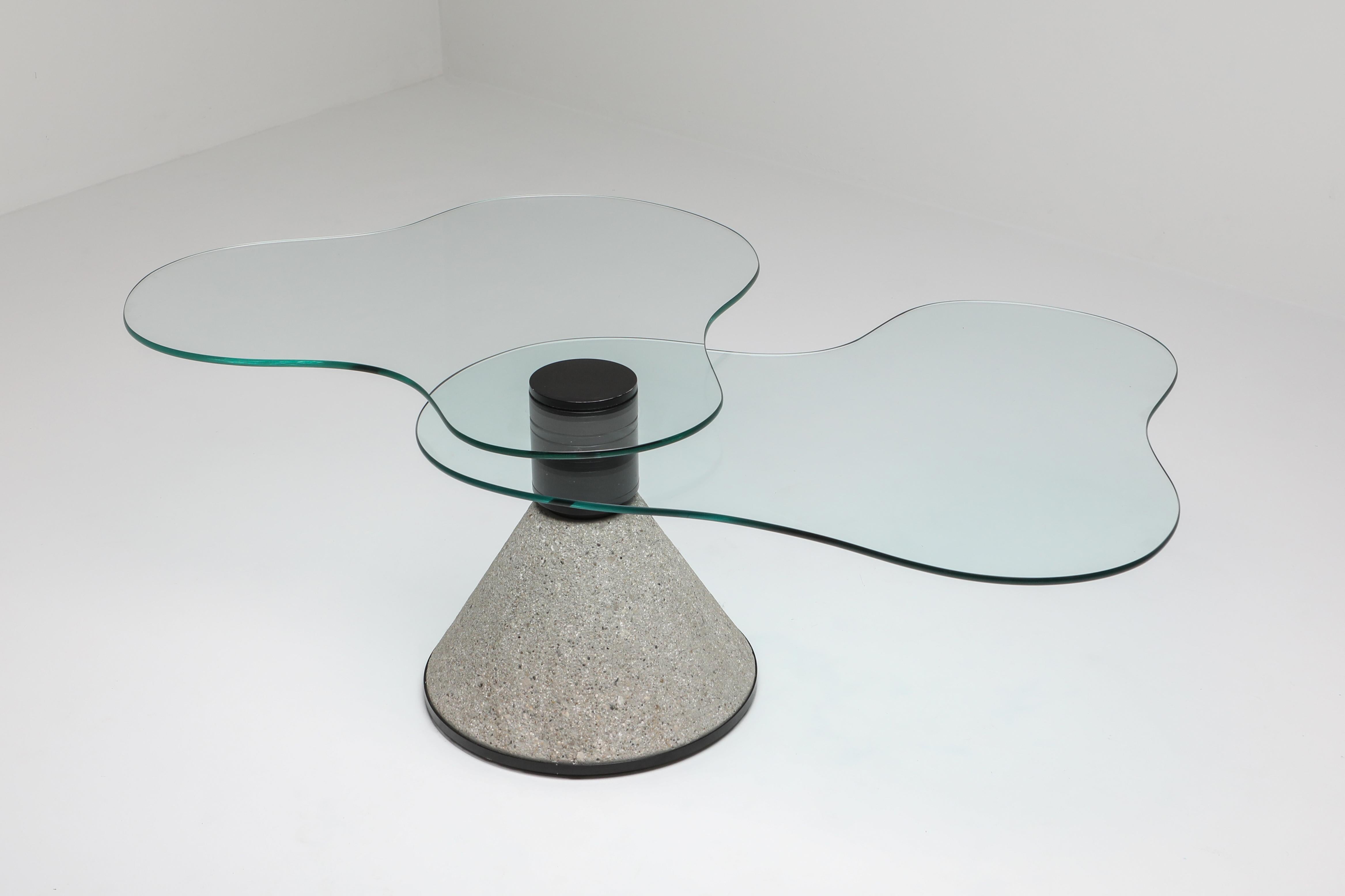 Memphis style coffee table in the manner of Saporit, Italy, 1980s

Striking coffee table on a conical concrete base with two rotating glass surfaces.


  