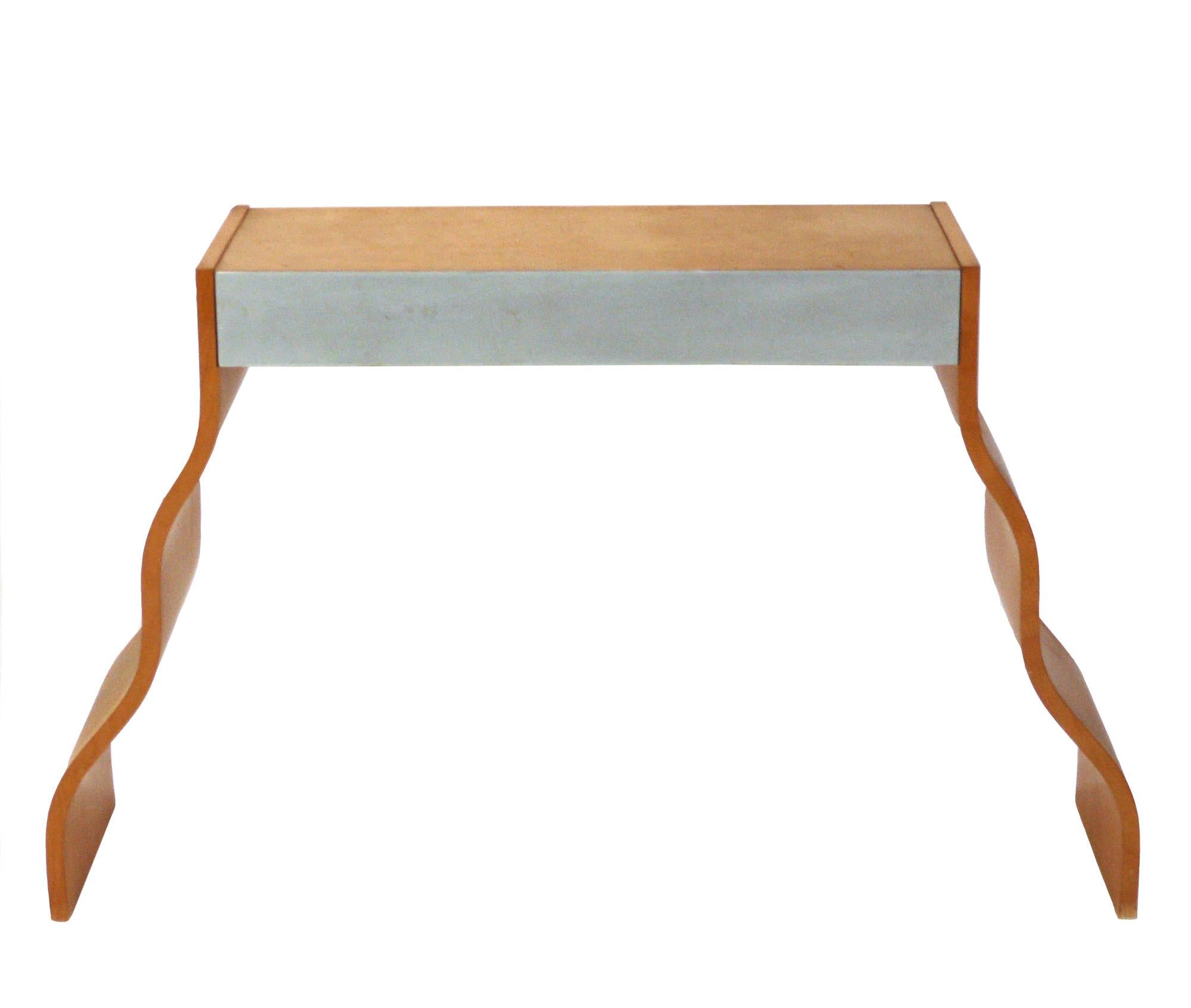 Post modern console table, American, circa 1980s. This sculptural piece is a versatile size, and can be used as a console table, sofa, table, desk, vanity, or bar. It measures 46 inch width at the base, 31.5 inches width at the top.