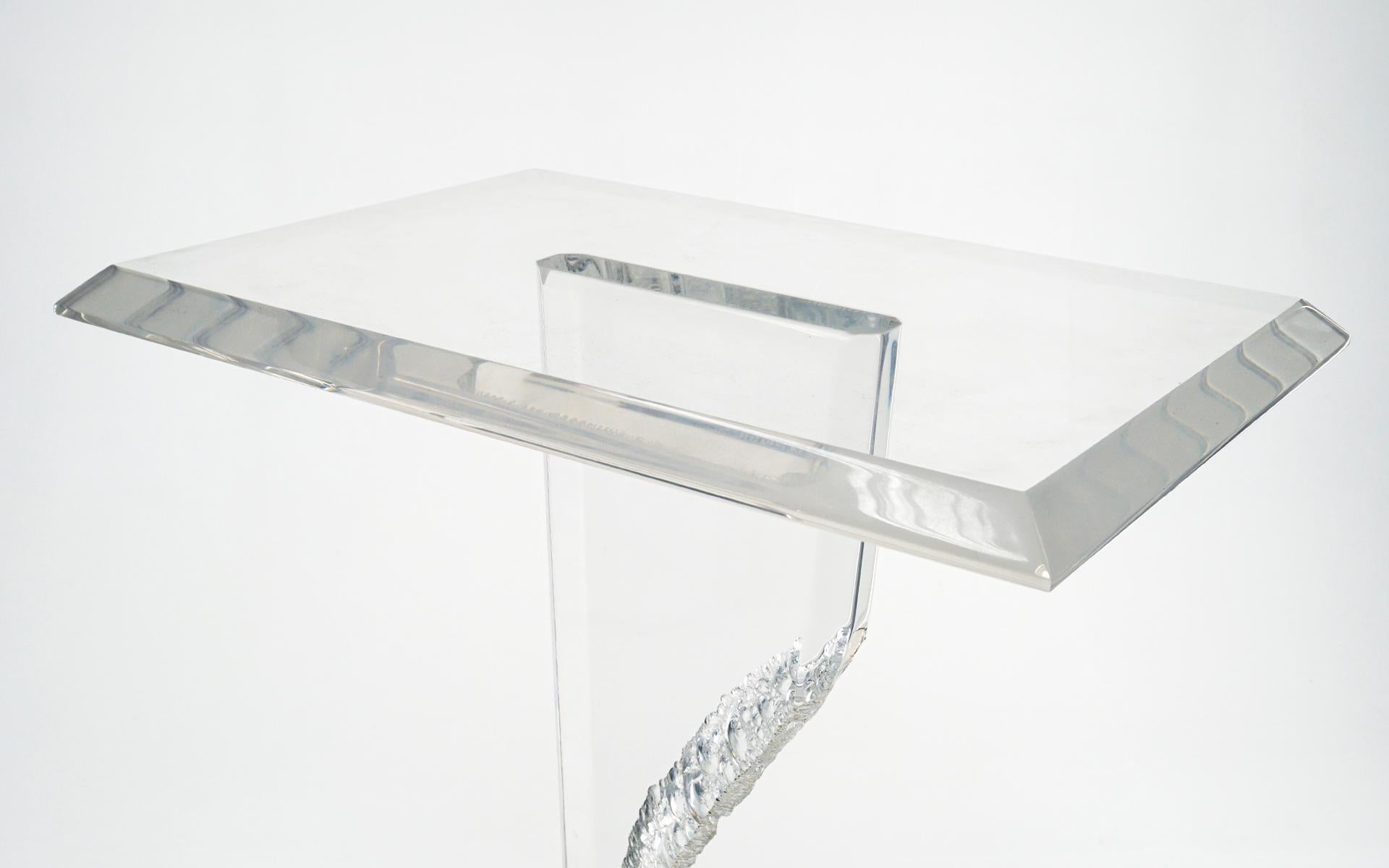 Modern / Contemporary pedestal / display stand in black and clear Acrylic. Very good condition with few if any signs of use. Very well made and sturdy. One inch thick clear lucite support cut in an abstract irregular form. The acrylic top is free of