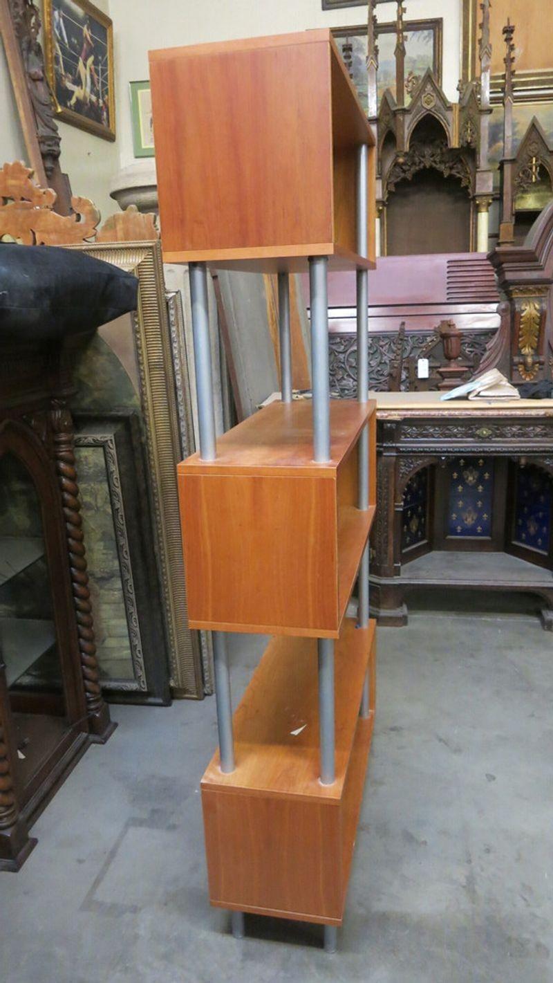 Vintage 1990s post modern cubist steel rod book shelf featuring 3 wood rectangle cubes fixed to 4 rods.
 
circa 1990.