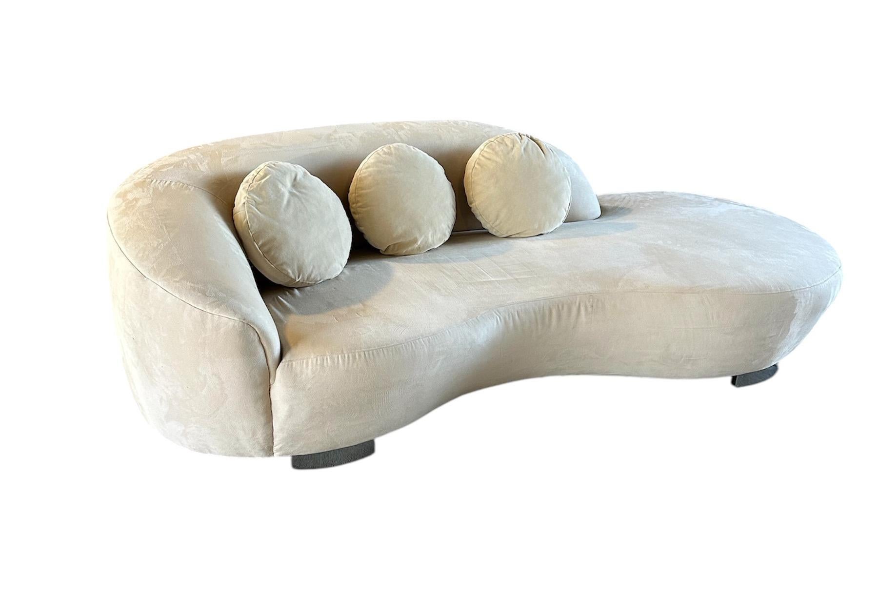 This curvaceous sofa is brought to life by Lazar Industries. With its post-modern aesthetic and expertly crafted construction, this striking piece adds a touch of sophistication to any living space. Embrace the unique style and superior quality of
