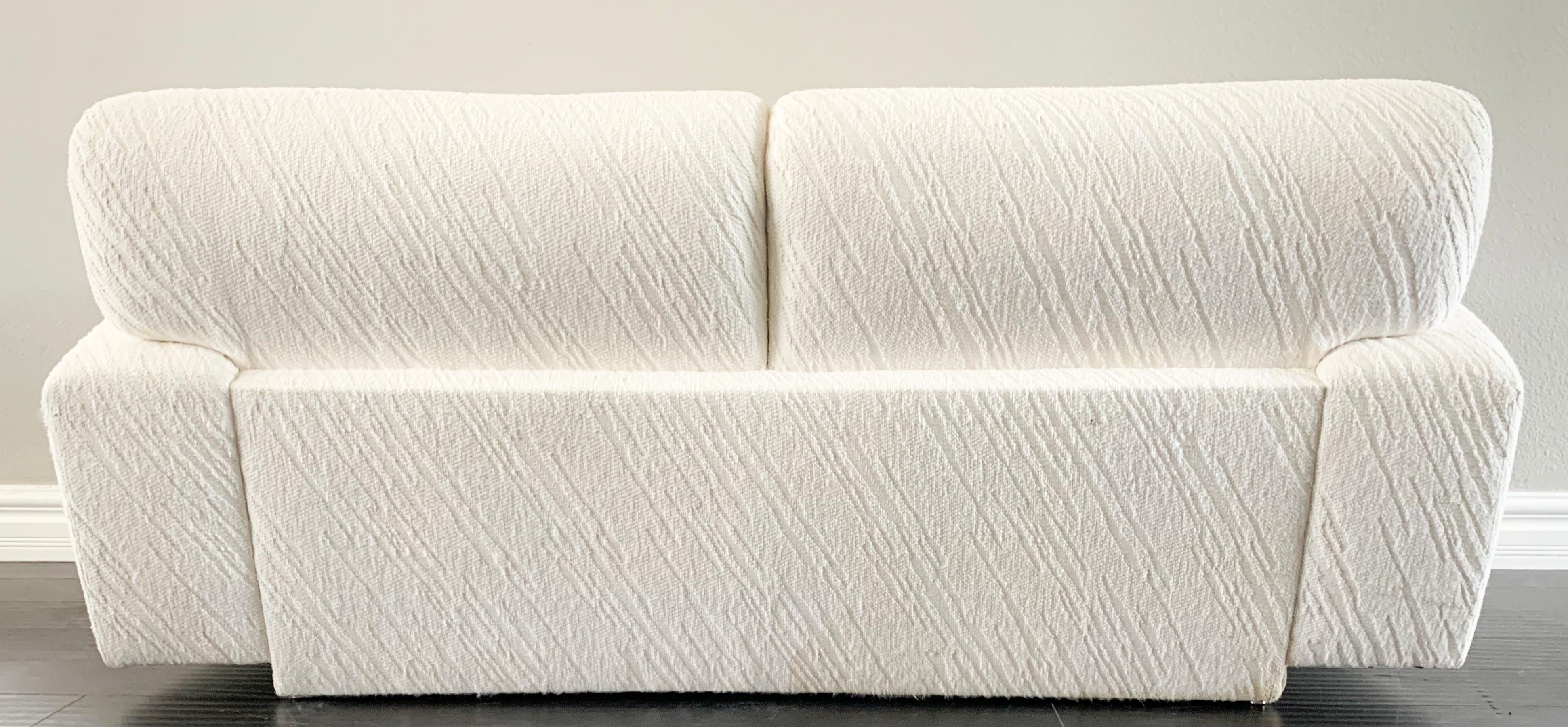 Available right now we have this gorgeous white loveseat sofa. This sofa's curves rival that of Kim Kardashian any day! The curvy silhouette and cool modern plinth base give this Postmodern sofa a wonderful, clean look that is sure to bring a touch