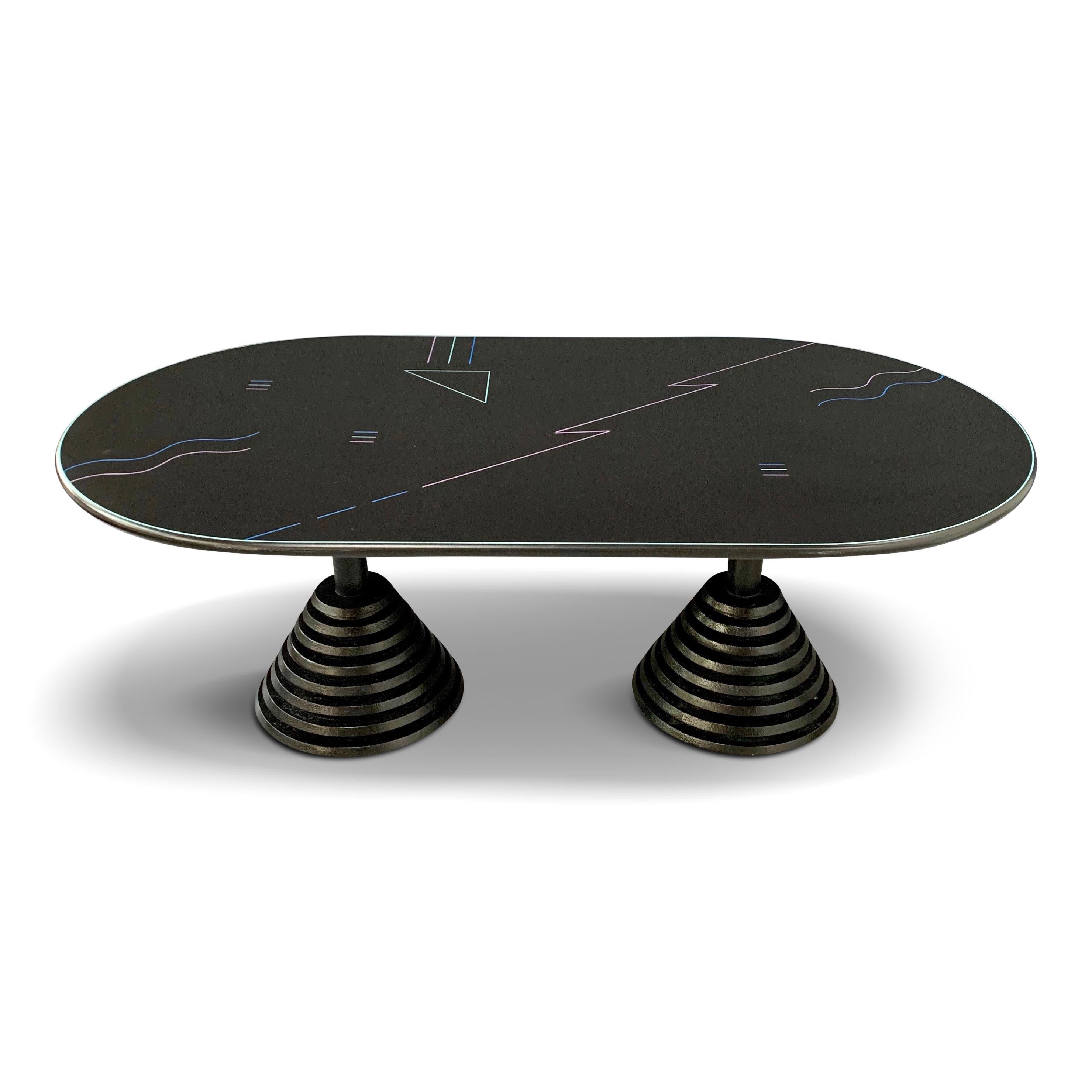 A Classic Postmodern designed desk or dining table with an inlaid colorful pattern on the top and stepped pyramid shaped legs.