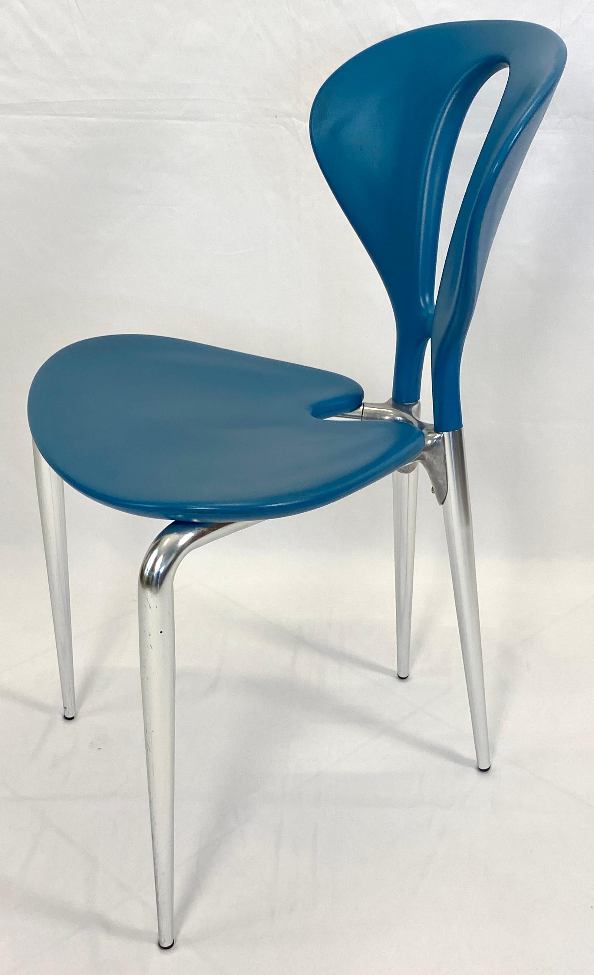 Modern dining table and 4 chair set. 

The sleek and stylish post modern table attributed to the renowned Italian company Driade boasts a round frosted glass top poised atop three legs crafted from cast aluminum. The sloping legs, with their