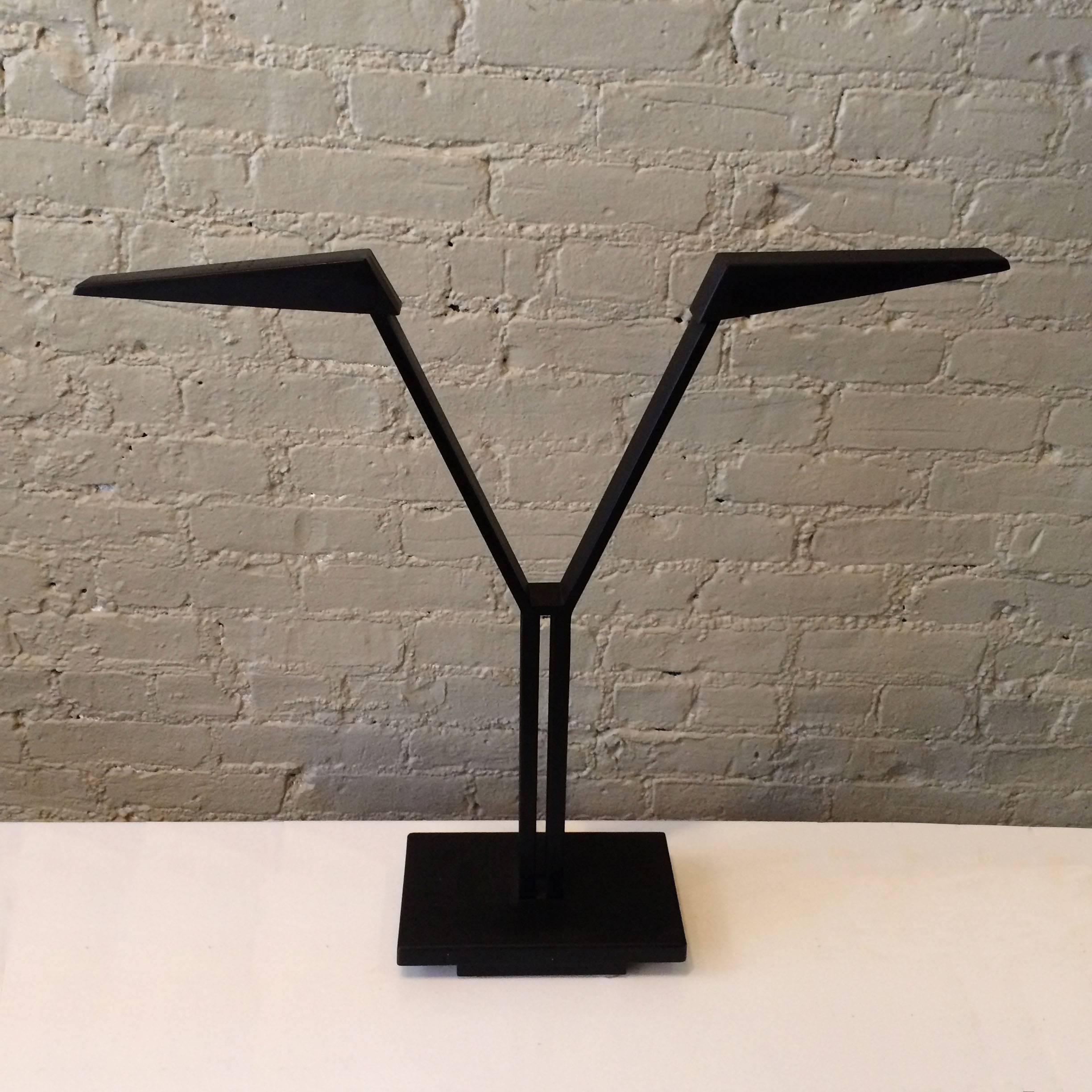 Impressive, Italian postmodern, black cast metal, double-headed, desk lamp by Roverto Maracatti for Zeus Milano features articulating heads that accept one Halogen bulb each.