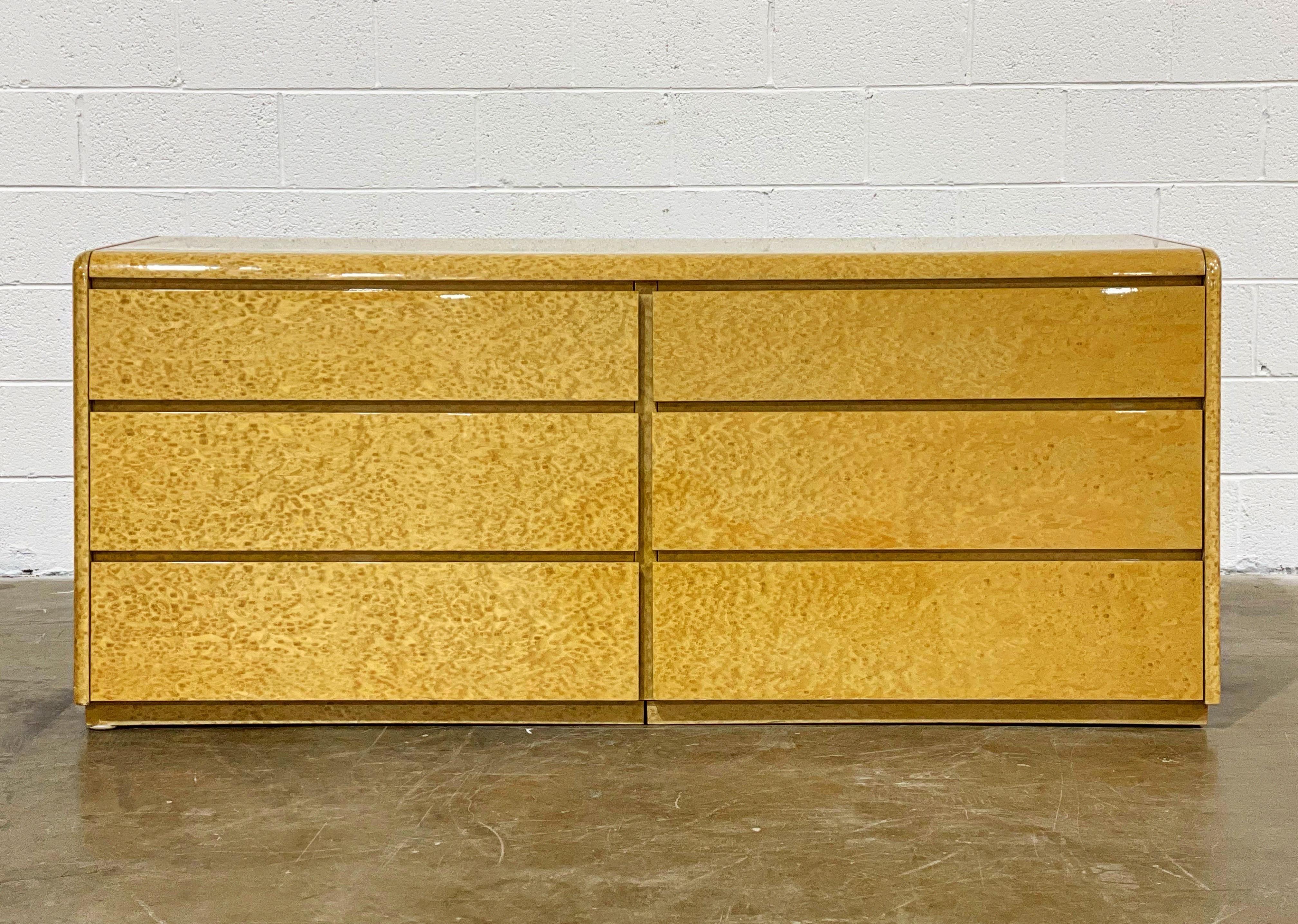 Unique on the market - exquisite midcentury six drawer dresser by COMA, Italy circa 1978. Stunning lacquered birdseye maple. Drawers operate smooth and retain the original foil COMA label. Excellent time capsule condition with no flaws of note.