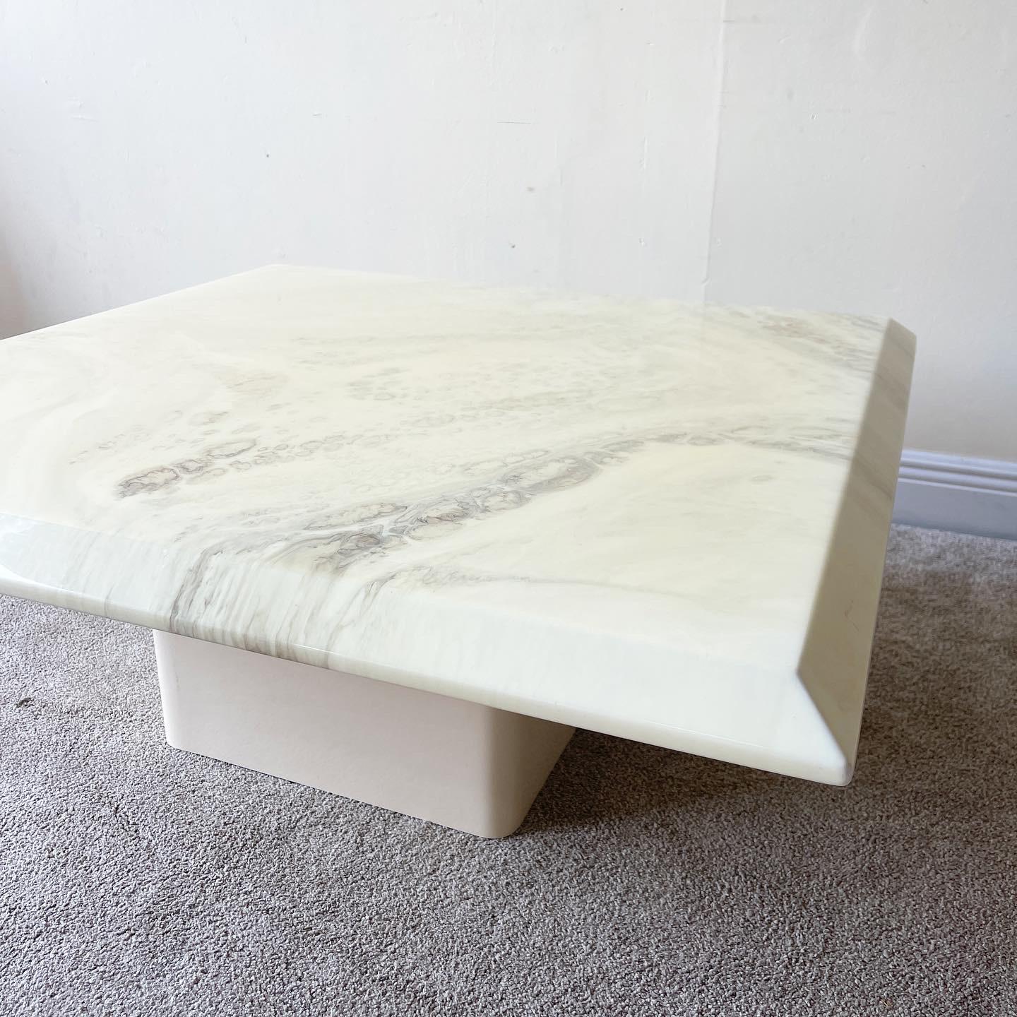 Incredible faux marble top square coffee table. Top is an epoxy over marbles design on a wood table. Table rests on off white lacquer laminate base.

Additional information:
Material: Wood
Color: Cream
Style: Postmodern
Time Period: