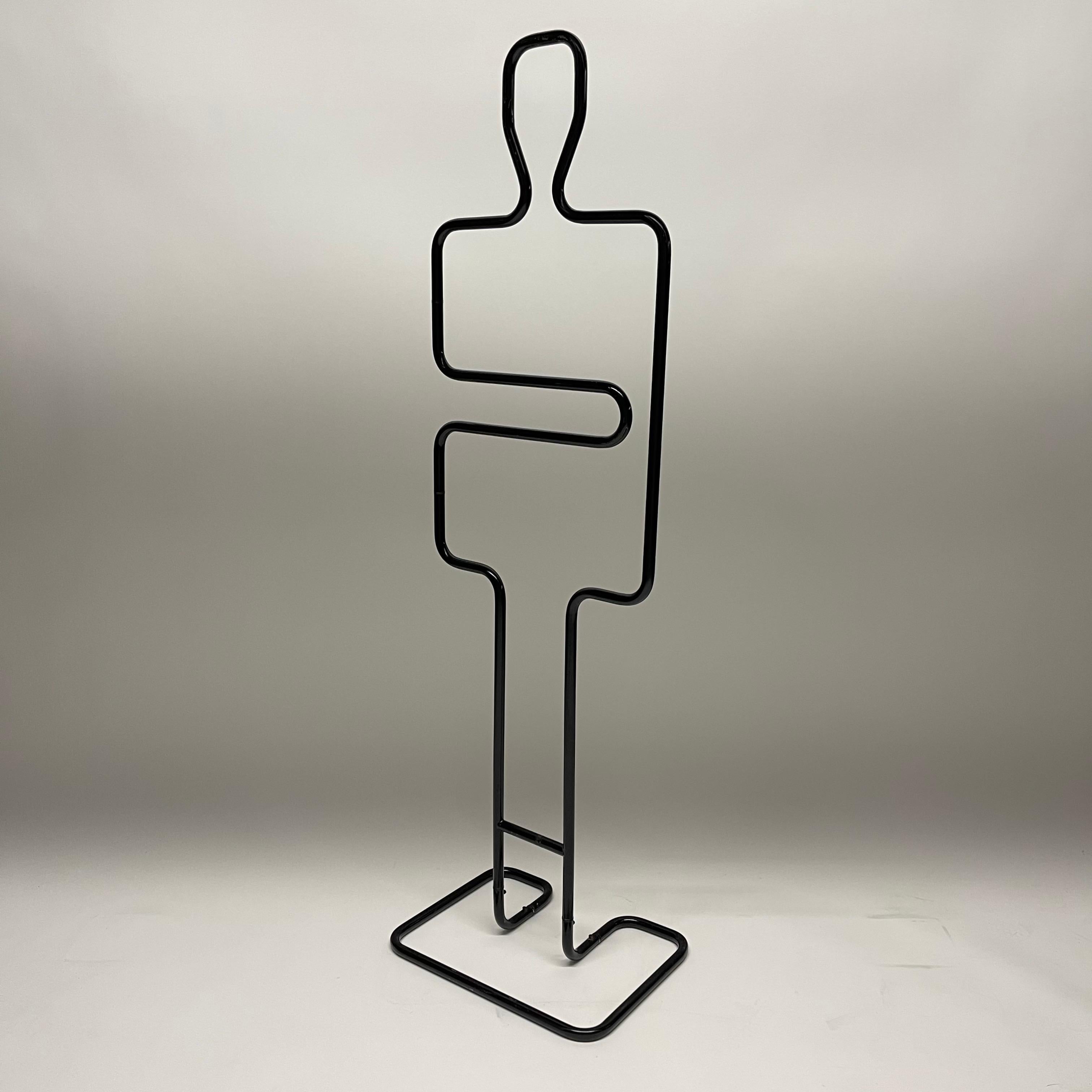 Figural Post Modern valet/coat or towel rack rendered in black powder coated steel with an articulating arm attributed to Pierre Cardin.