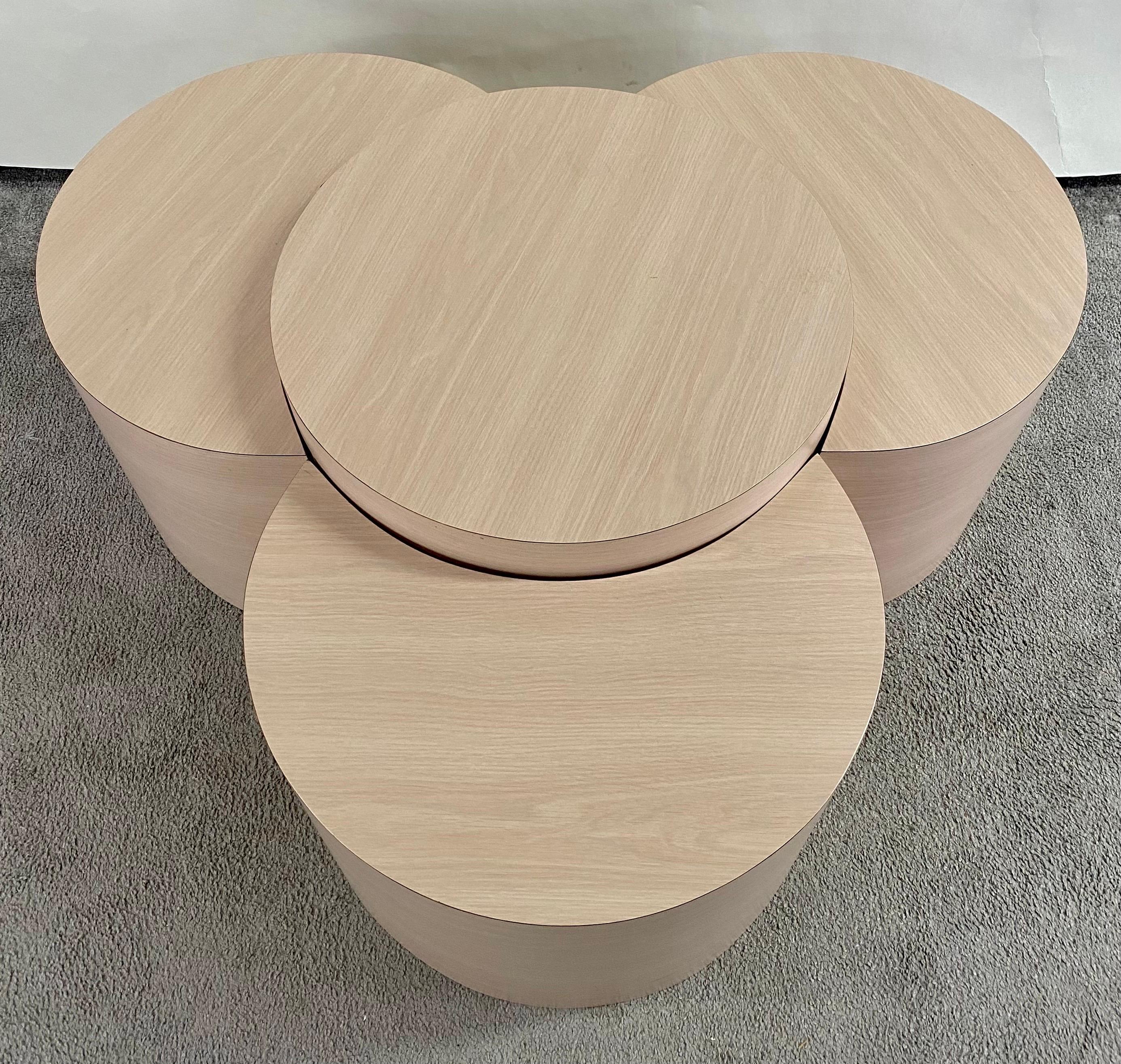 Introducing a truly versatile addition to your living space, a post-modern four-piece Formica laminate drum table set, elegantly finished in a soothing light pink hue. These tables offer not only a delightful touch of retro charm but also a world of
