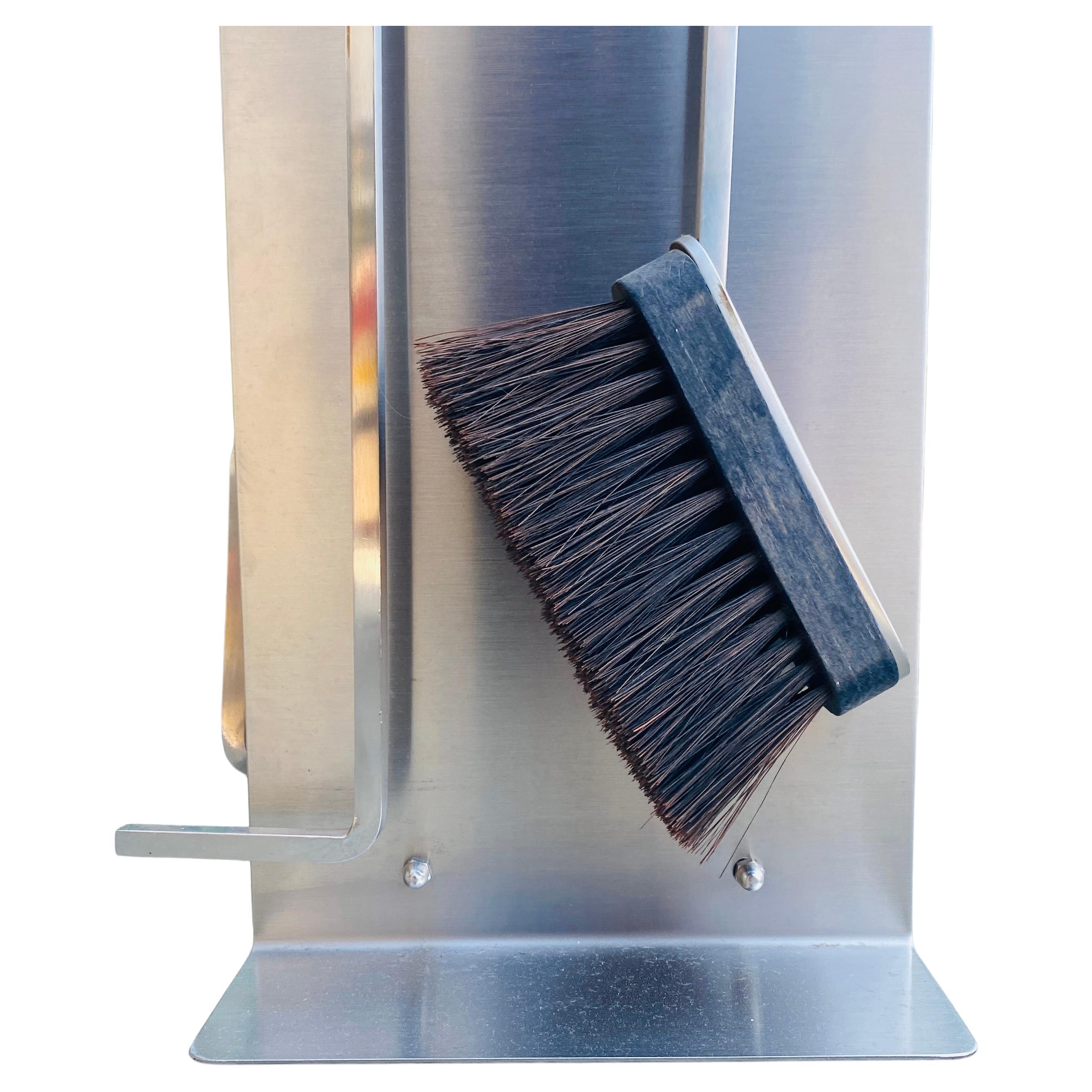 A rare fireplace tool set by François Monnet, made in France in the 1970s. The set includes fireplace tongs, a fire poker, a fireplace shovel, a fireplace brush, and a place to store all of the tools. The post-modern fireplace tool set has a top