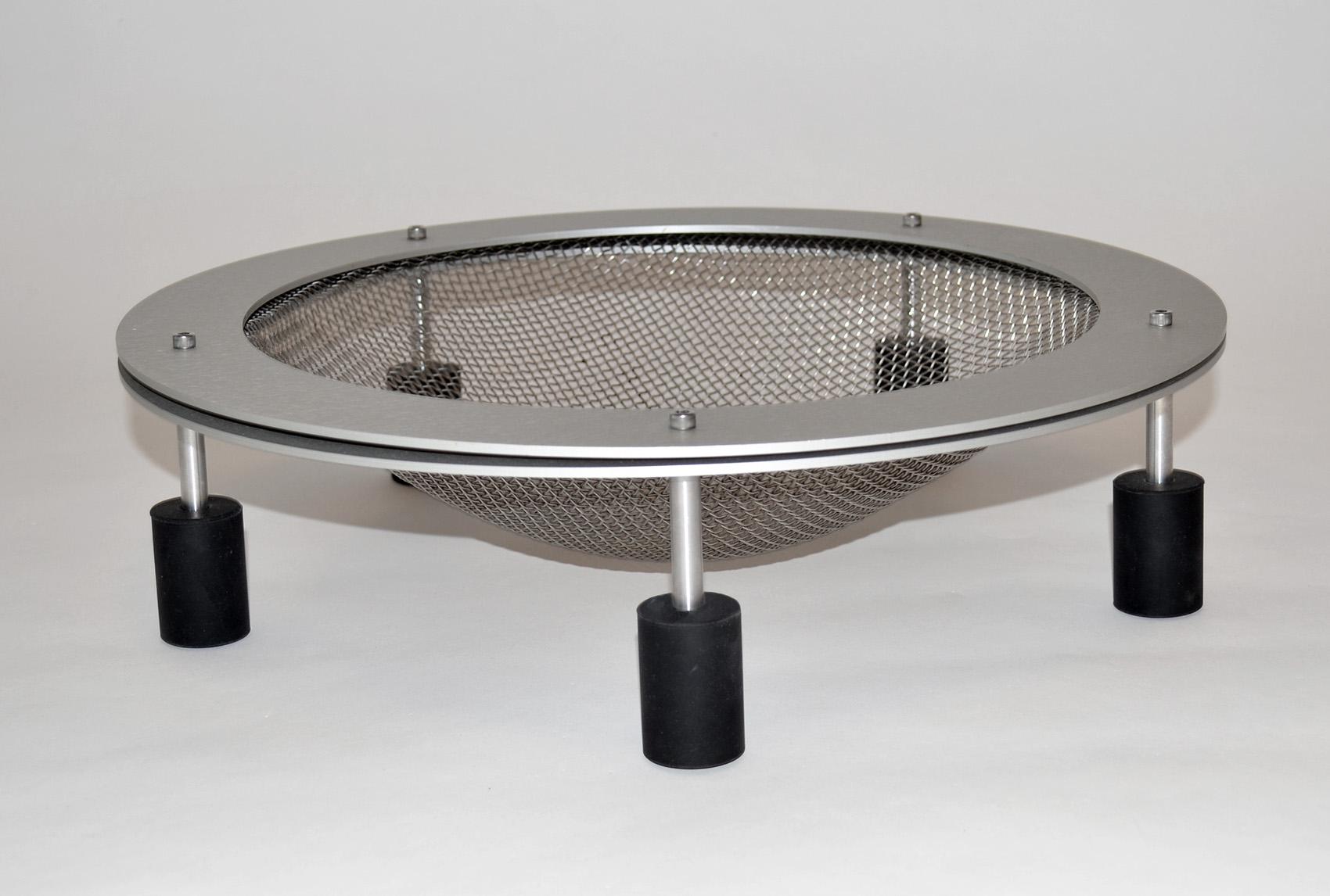 Post Modern Fruit Bowl, Basket, Catch All or Vide-Poche 1990s
Machined aluminum mesh screen supported by aluminum legs with metal fasteners on rubber feet. Created by HOK Product Design. Purchased from the BP building, Cleveland, OH. HOK label on