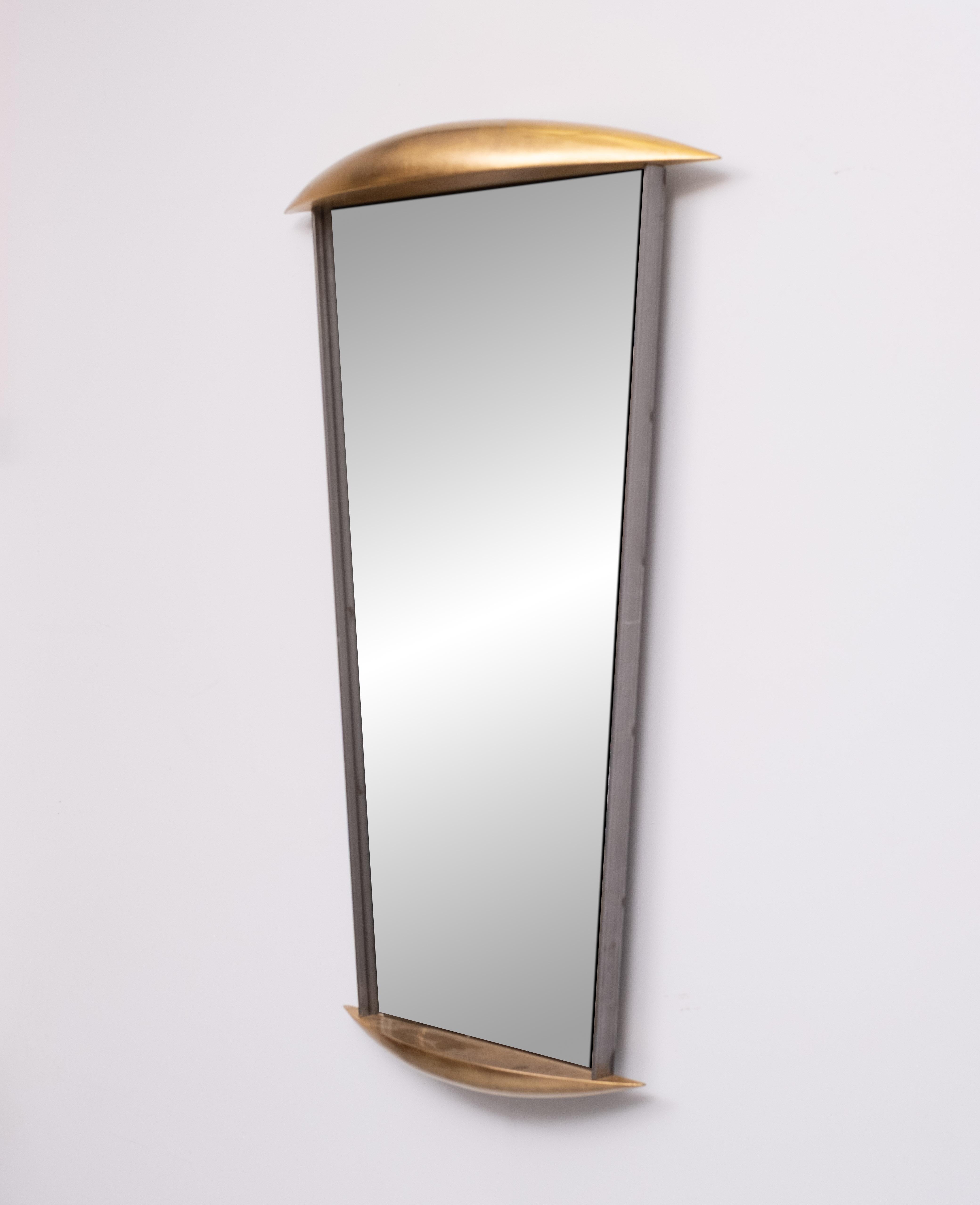 Beautiful Full-length wall mirror with wooden and metal profiles. The upper and lower profile has two semi-ovals in wood with gilded  golden finish. On the sides it has two thin metal plates. 1980s. 

     