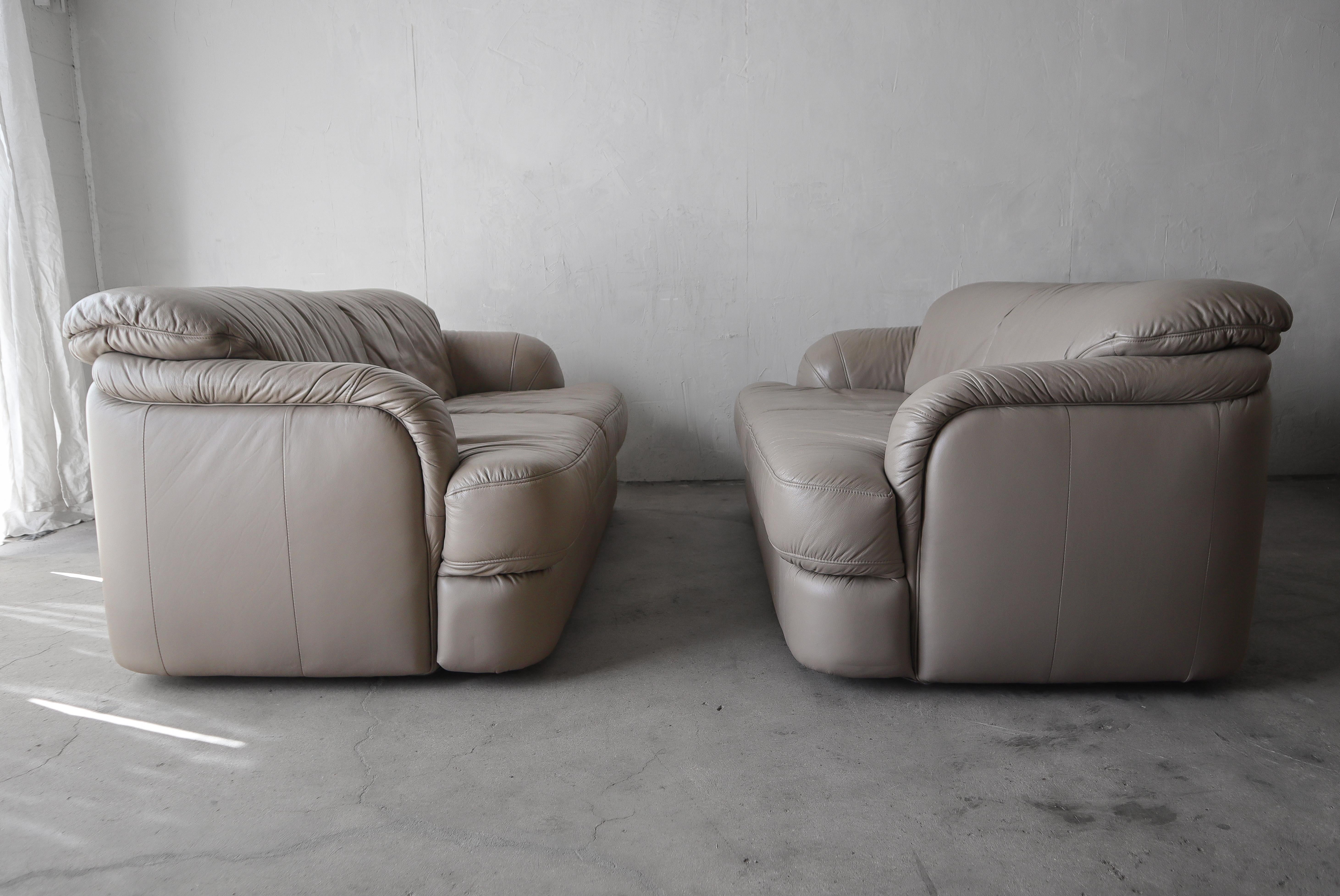 Nice pair of Post Modern Leather Loveseats made in Germany.  

Sofas are in overall good condition.  There is some wear to the leather as seen in the last few photos, but they are free of an real damage, stains or odors.

**Color is a taupe that