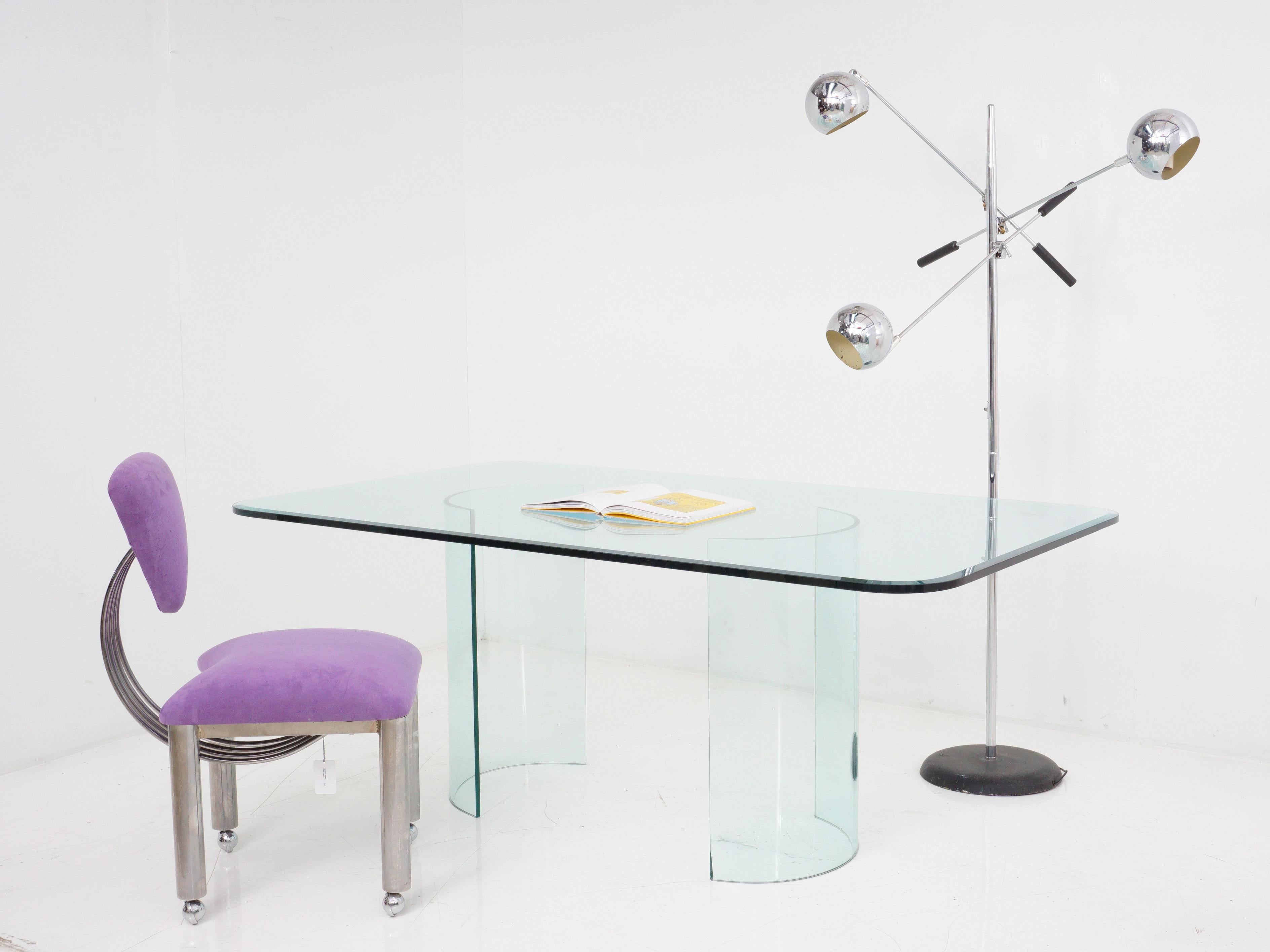 With its bent glass legs defying gravity, the postmodern glass dining table is the ultimate conversation starter for dinner parties - it's like dining on a work of art that just happens to hold your food.

- 72