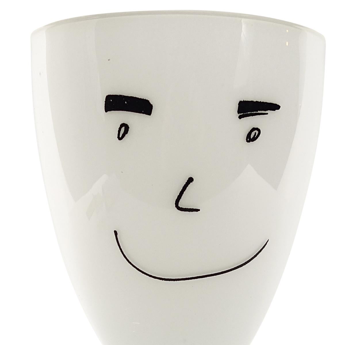 Cheerful glass vase designed by Roger Selden for the Vis-à-vis Collection of Ritzenhoff, 1999.

This black and white vase from the Vis-à-vis Collection has a stylized cartoon character painted on it. It is highly inviting to put in a wild bunch of