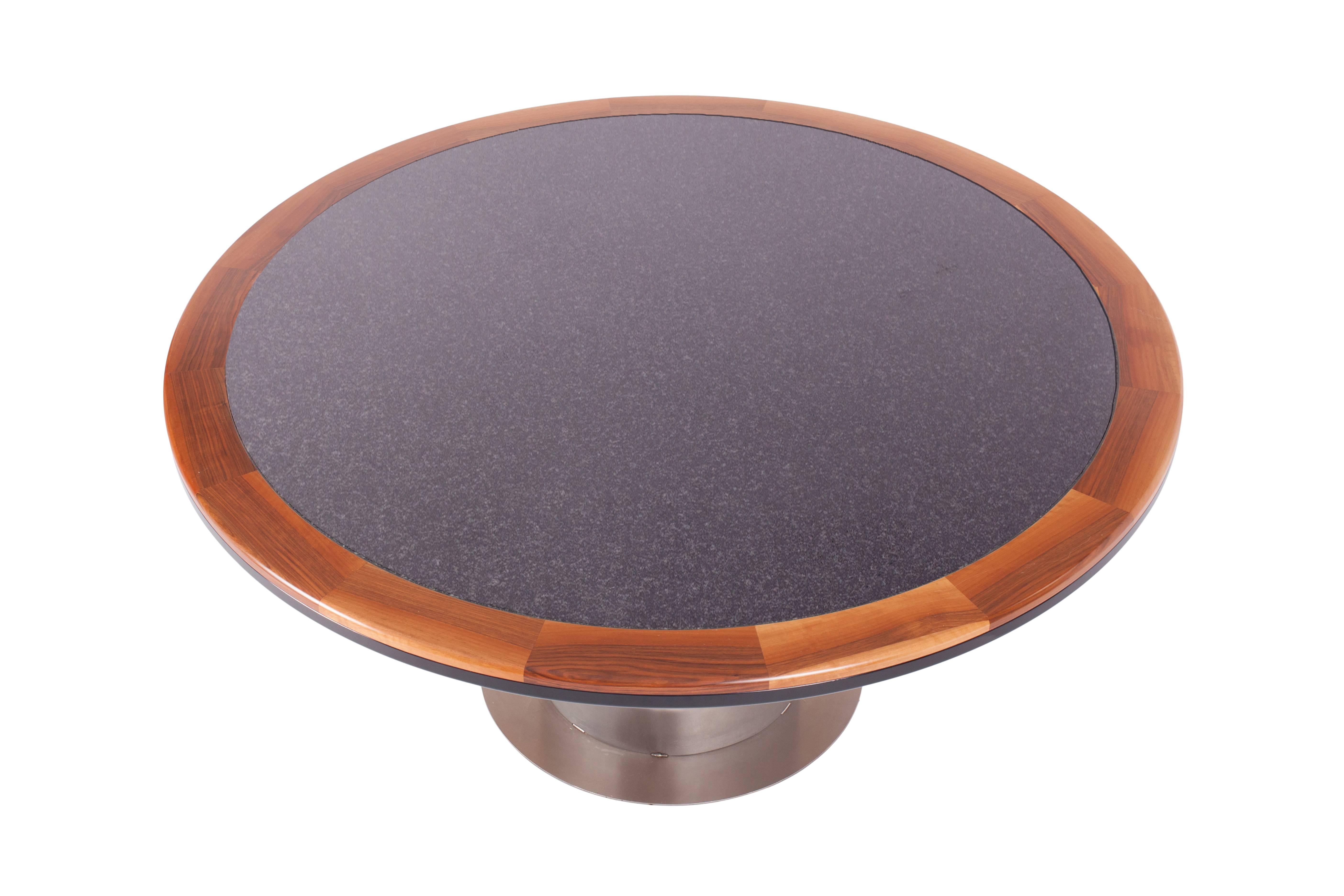Maria Pergay style Luxury round dining table in yacht style.

A granite table top with a solid walnut and black lacquer edge,
mounted on a stainless steel base

European 1980s.

Measures: Ø 160 cm, H 74.5 cm.

 