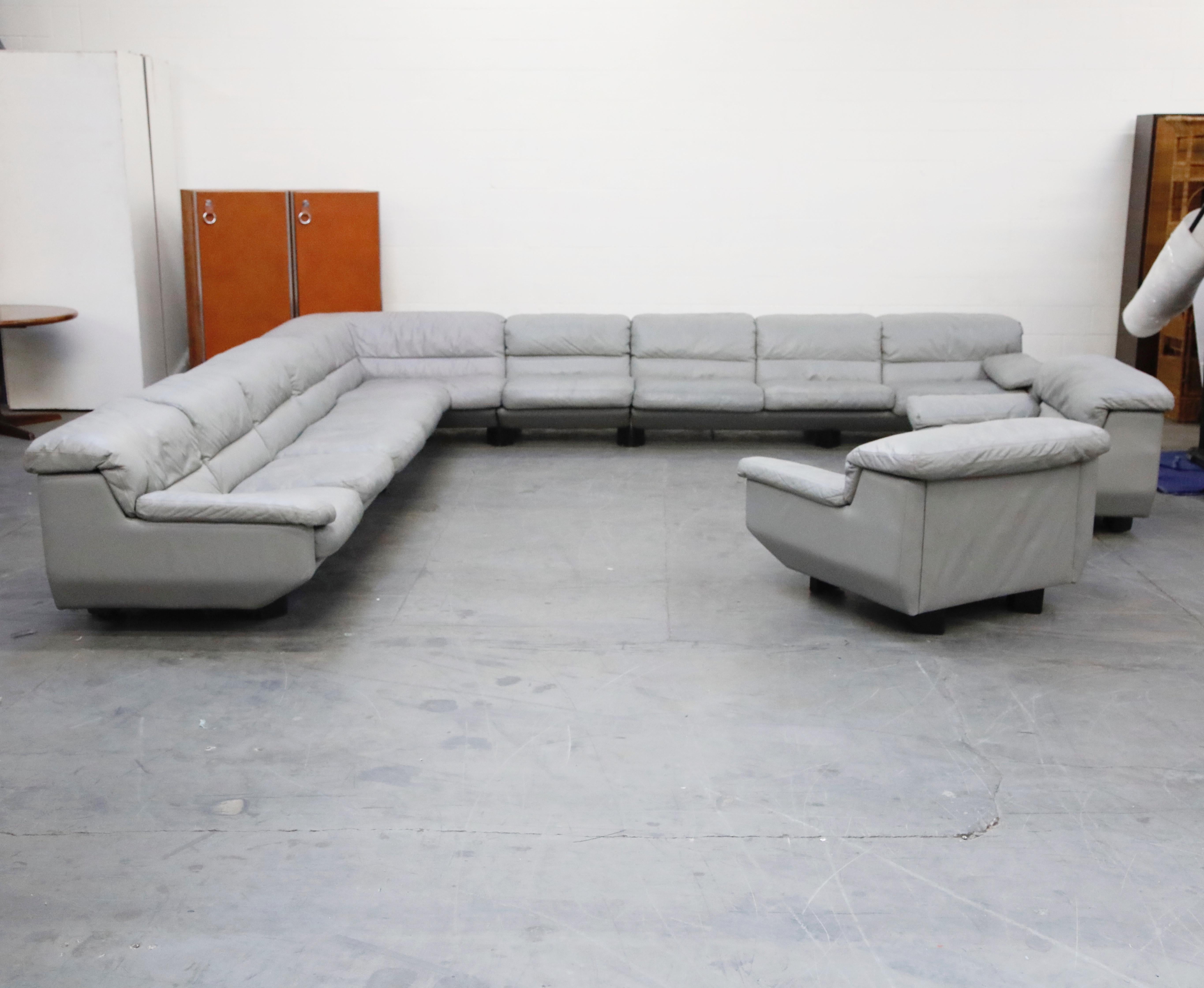 This incredibly huge Postmodern gray leather living room system is by Preview, signed with original labels on each section and date stamped 1988. The modular set comprises of a corner section, two long 3-seat sections each with one arm, two single
