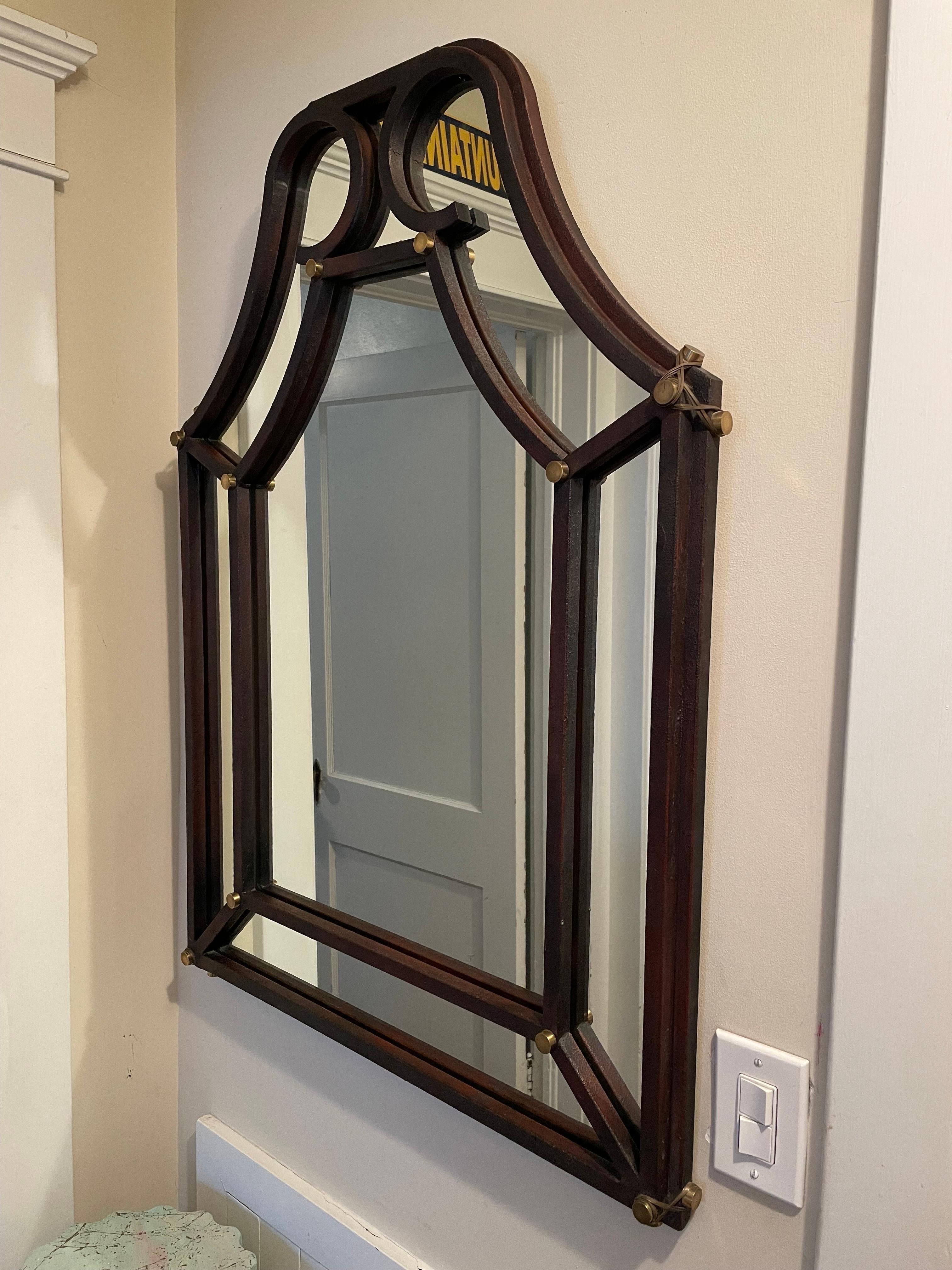 Wonderful Hart Associates post modern cathedral mirror in brown with auburn highlights and brass hardware. Brass accent corner buttons wrapped with brass banding. Frame is stepped for a heafty 1.75